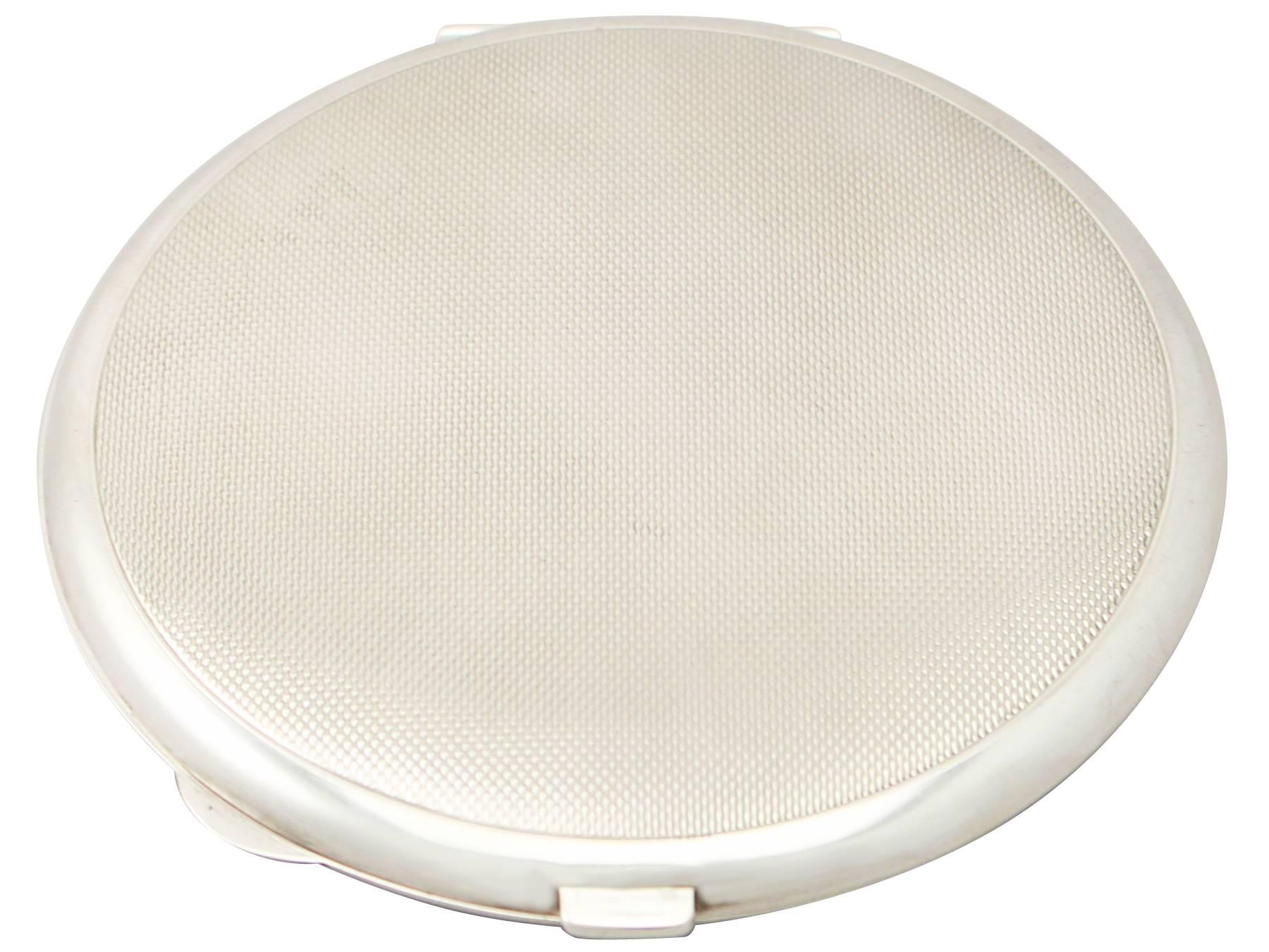An exceptional, fine and impressive vintage George VI English sterling silver and enamel compact; an addition to our ornamental silverware collection

This fine vintage George VI sterling silver and guilloche enamel compact has a circular rounded