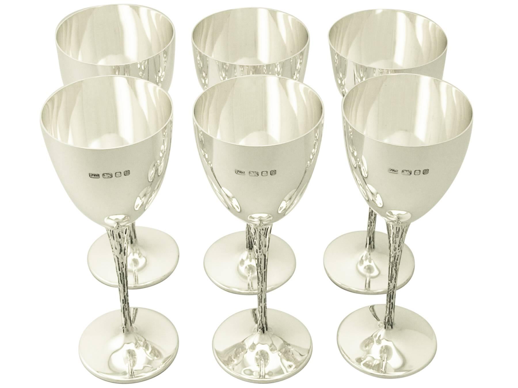 A fine and impressive set of six vintage Elizabeth II English sterling silver goblets; an addition to our range of wine and drinks related silverware These Fine vintage Elizabeth II sterling silver goblets have a plain rounded bell shaped form onto
