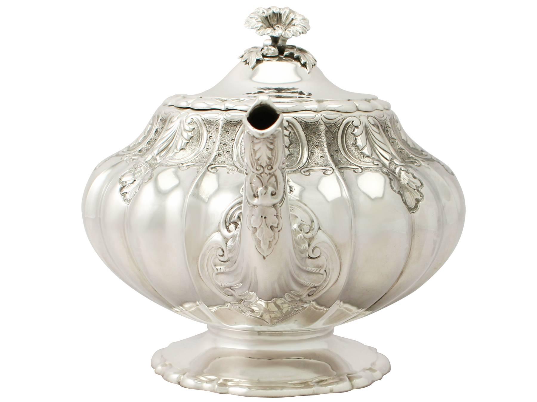 An exceptional, fine and impressive antique Victorian English sterling silver teapot; an addition to our silver teaware collection

This exceptional antique Victorian sterling silver teapot has a melon shaped form.

The upper portion of the