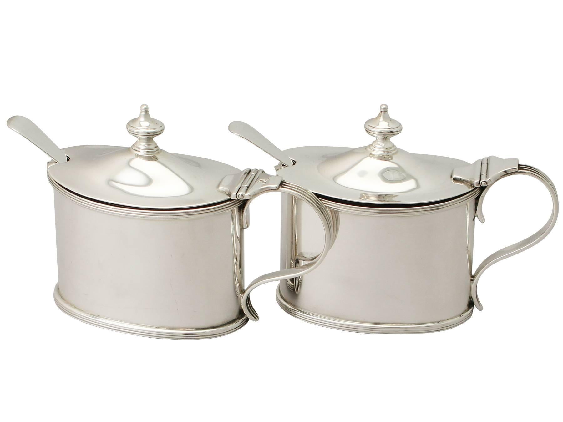 An exceptional, fine and impressive pair of antique George V English sterling silver mustard pots; an addition to our silver cruet and condiments collection.

These fine antique George V sterling silver mustard pots have a plain oval form.

The
