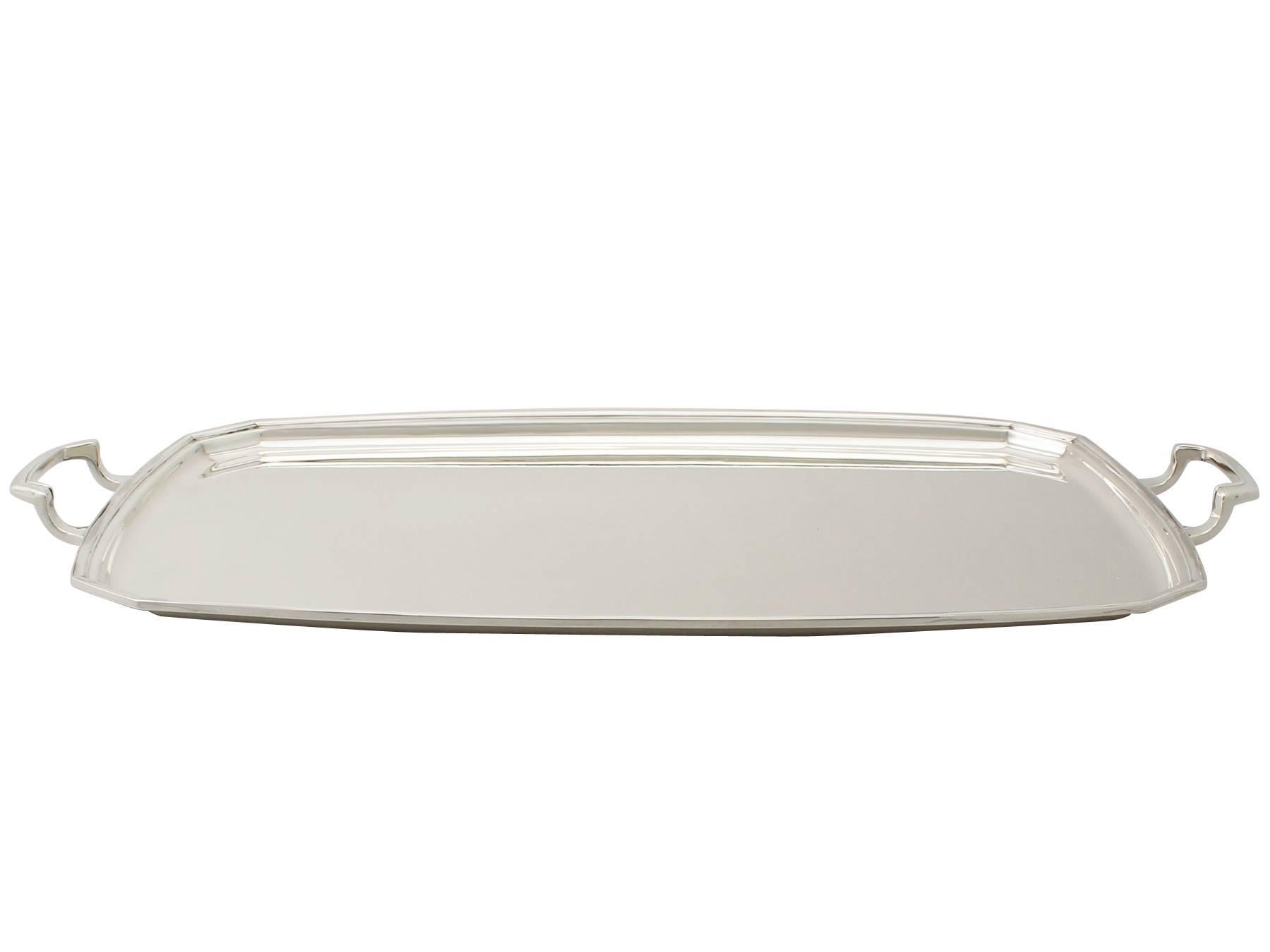 An exceptional, fine and impressive vintage George VI English sterling silver tray in the Art Deco style; an addition to our range of silver trays, salvers and plates.

This exceptional vintage George VI sterling silver tray has a plain