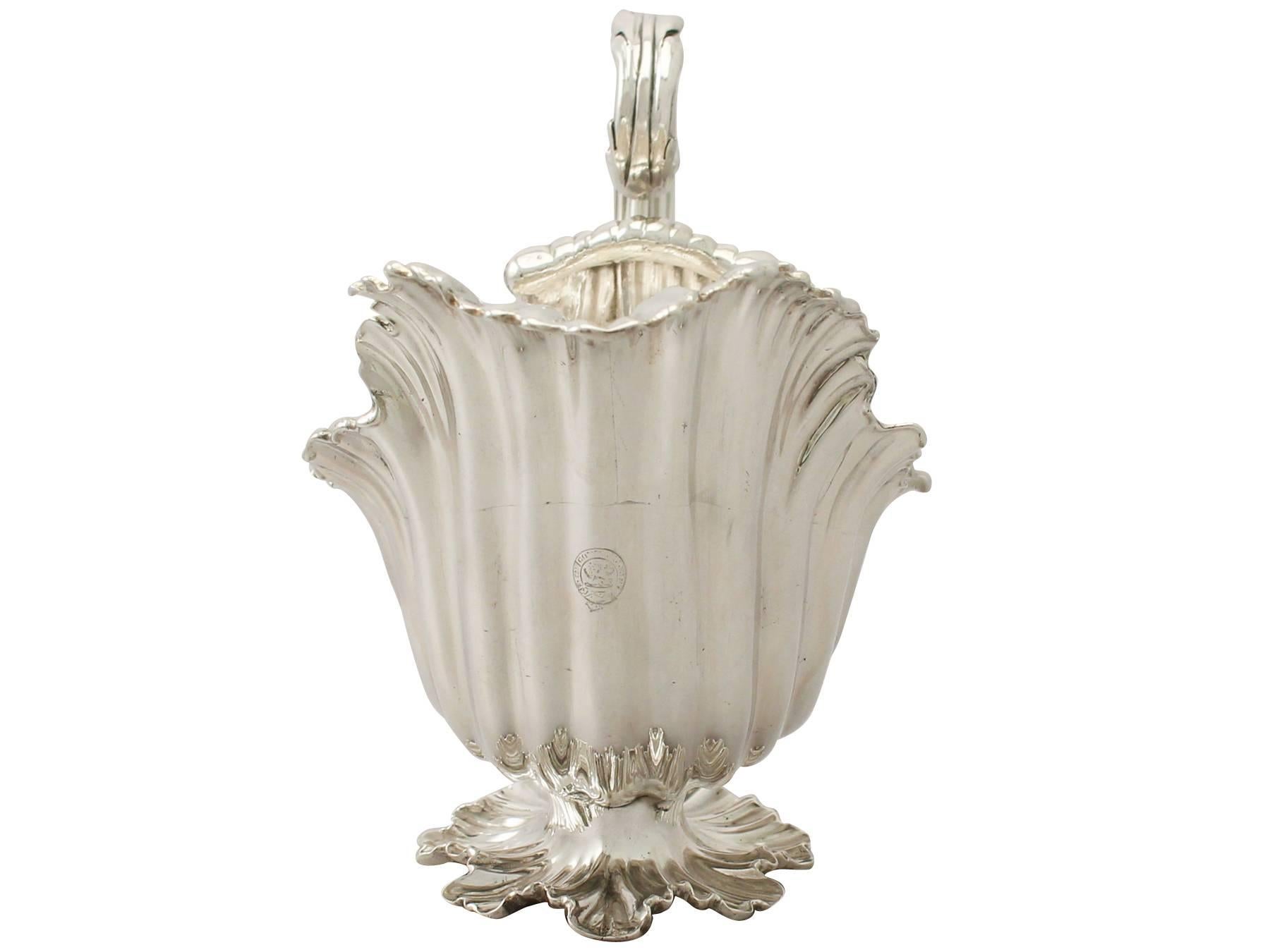 An exceptional, Fine and impressive, large antique William IV English sterling silver sauceboat/ gravy boat; an addition to our silver dining collection.

This exceptional antique William IV sterling silver sauceboat has an oval shaped form,