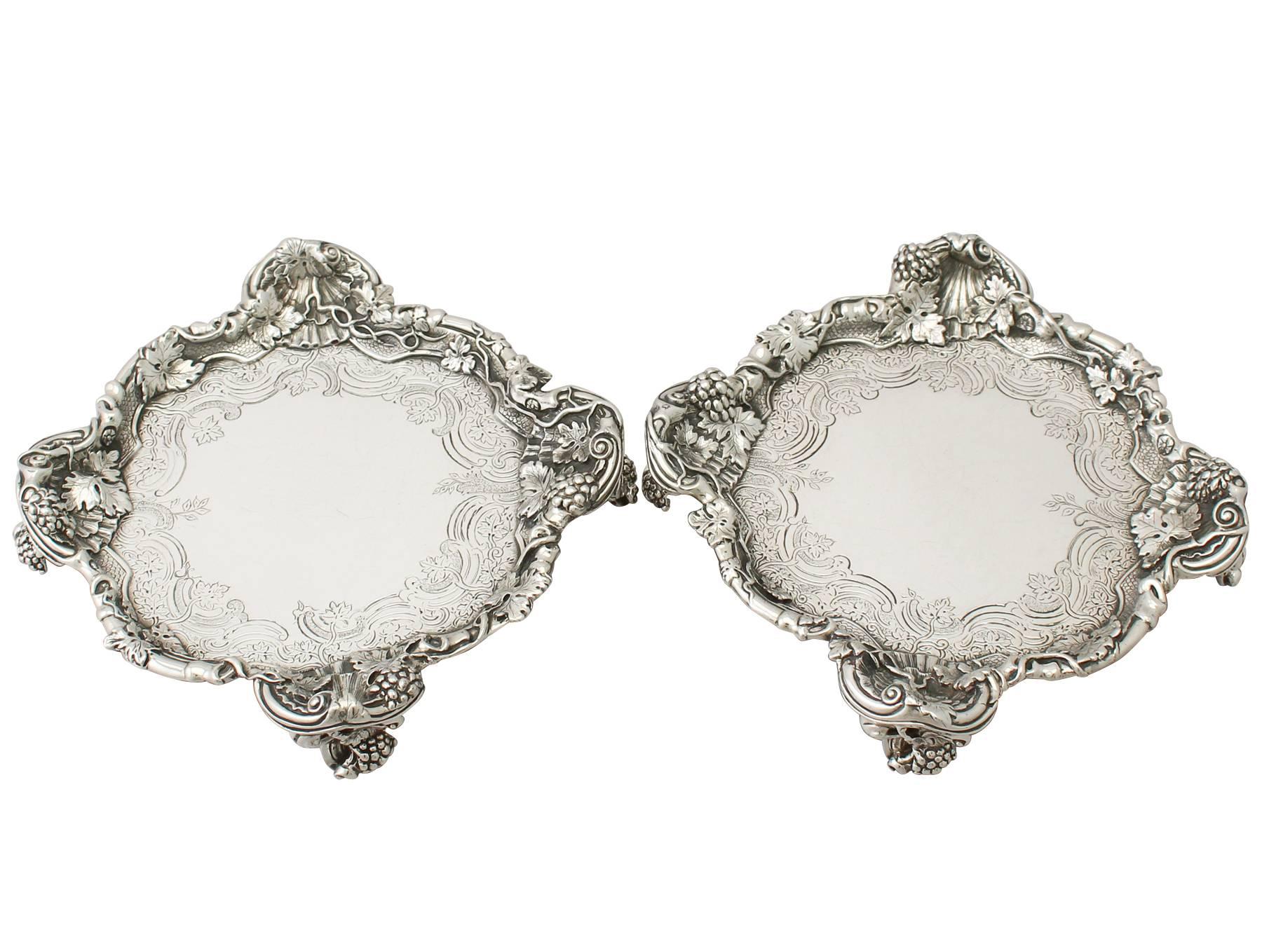 A magnificent, fine and impressive pair of antique Georgian English sterling silver salvers made in the Rococo style by Paul de Lamerie; an addition to our tray and salver collection.

These magnificent antique George II sterling silver salvers