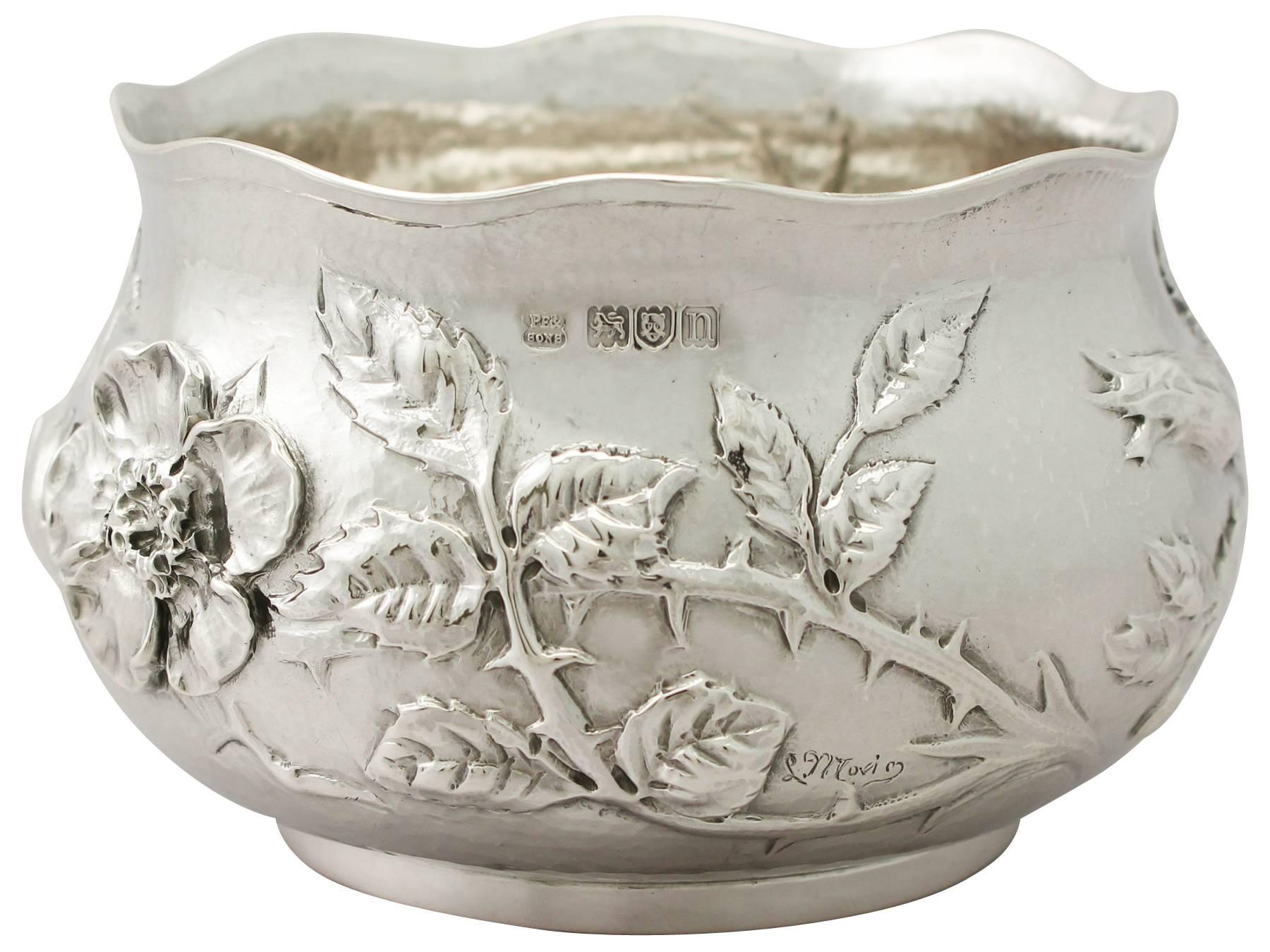 An exceptional, fine and impressive antique Edwardian English sterling silver bowl designed by Latino Movio in the Arts and Crafts style; an addition to our range of collectable silverware.

This exceptional antique Edwardian sterling silver bowl