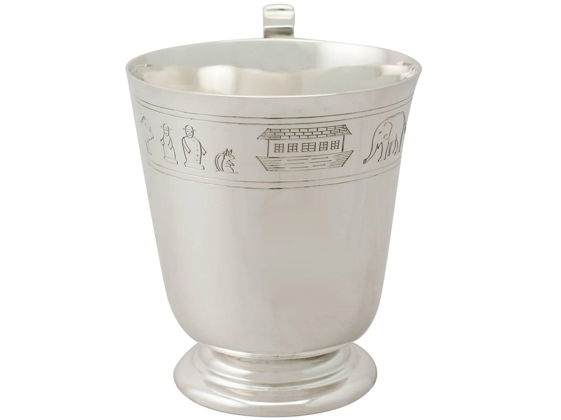 An exceptional, fine and impressive antique George V English sterling silver christening mug illustrating Noah's Ark and made in the Art Deco style; an addition to our religious silverware collection.

This exceptional antique George V sterling