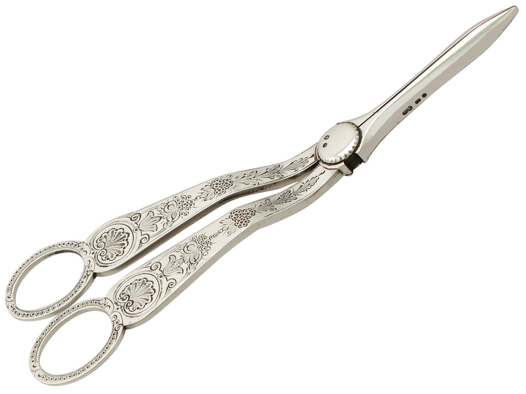 An exceptional, fine and impressive pair of antique Victorian English sterling silver grape shears; an addition to our silver flatware collection.

This exceptional pair of antique Victorian sterling silver grape shears has a hinged scissor