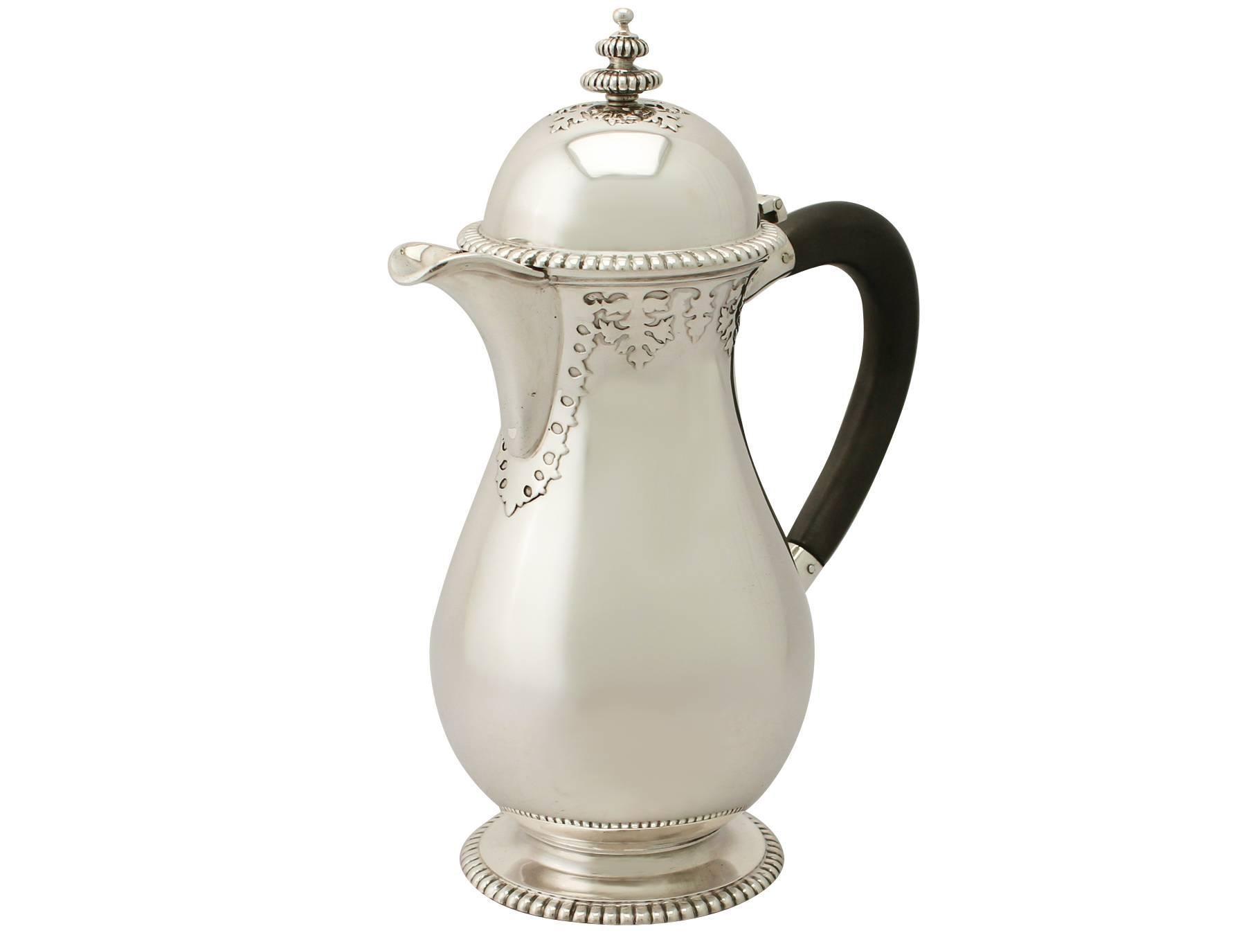 An exceptional, fine and impressive antique George V English sterling silver coffee pot/jug; an addition to the silver teaware collection.

This exceptional antique George V English sterling silver coffee pot/jug has a baluster shaped form.

The