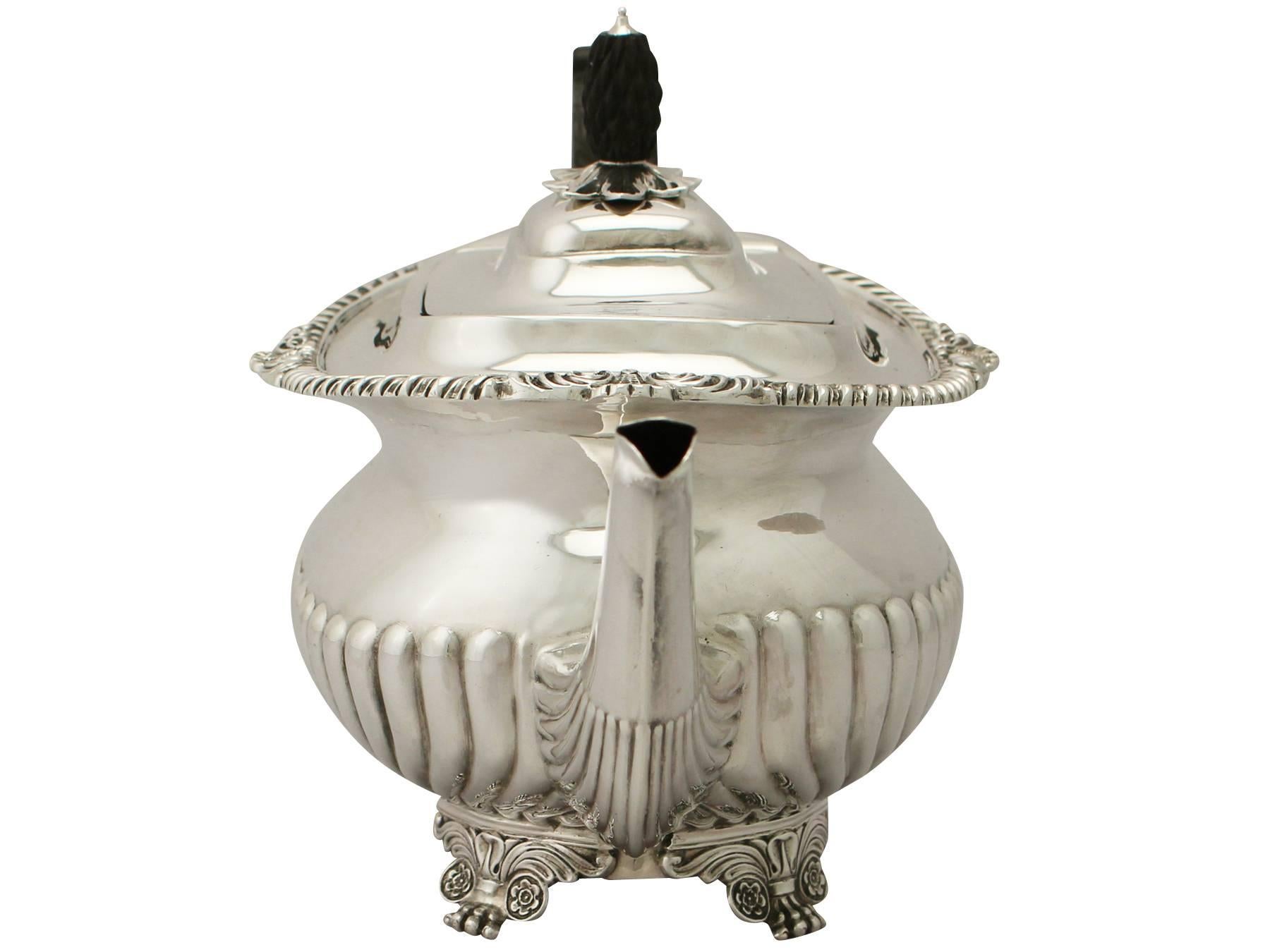 An exceptional, fine and impressive antique Victorian English sterling silver teapot; an addition to our silver teaware collection.

This exceptional antique Victorian sterling silver teapot has an oval rounded form onto four Regency style