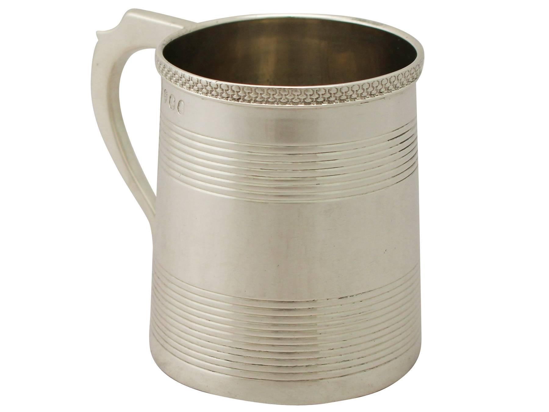 A fine and impressive antique Georgian English sterling silver christening mug, an addition to our christening gifts silverware collection.

This fine antique George III sterling silver christening mug has a plain tapering cylindrical form.

The