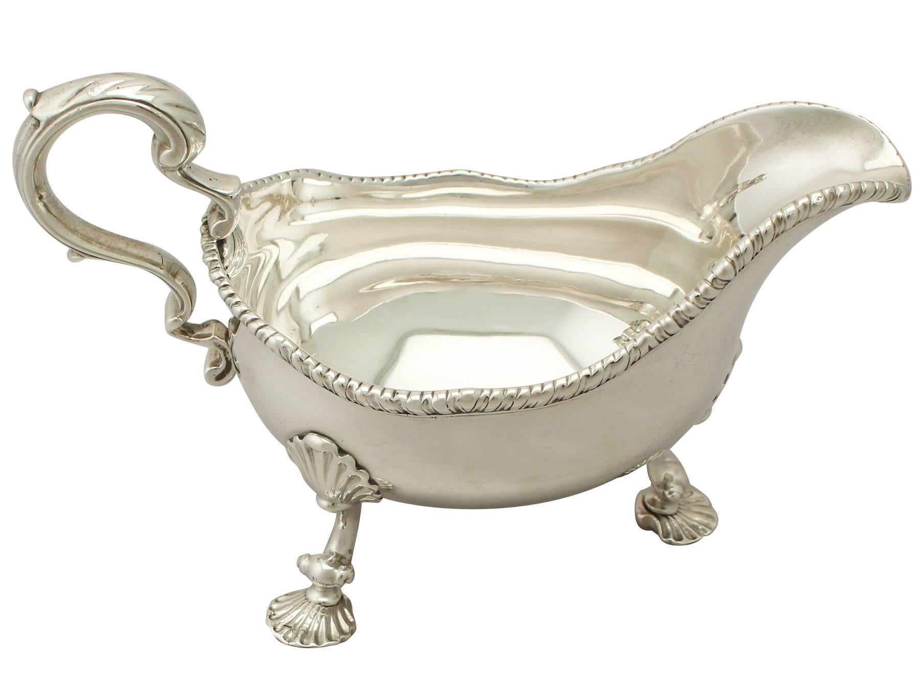 An exceptional, fine and impressive antique Georgian English sterling silver sauceboat/gravy biat; an addition to our silver dining collection.

This exceptional antique George III sterling silver sauce boat/gravy boat has a plain oval rounded