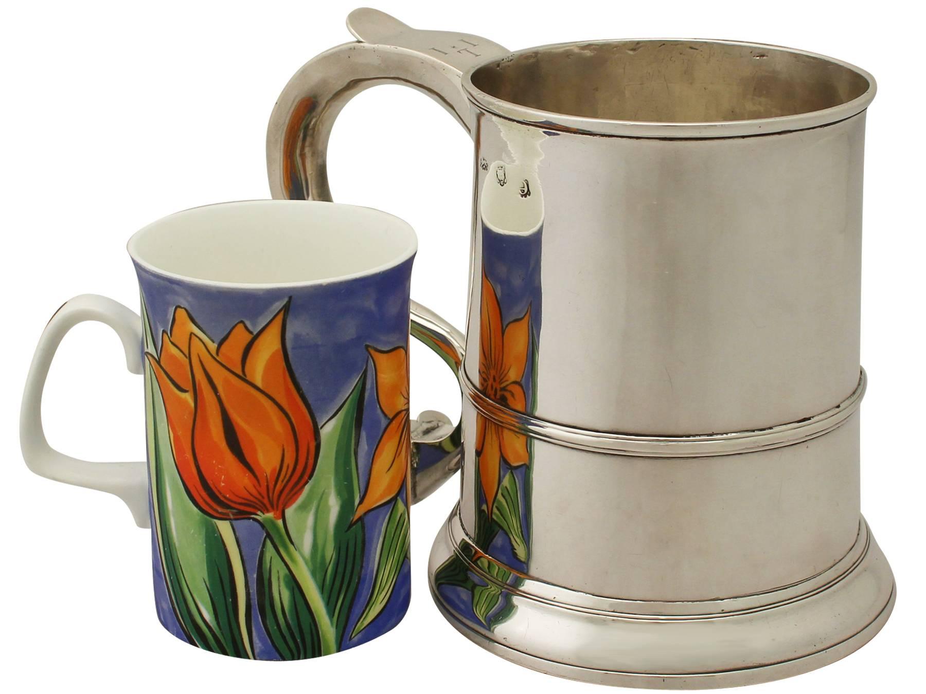 An exceptional, fine and impressive, large antique George II English sterling silver quart mug; an addition to our range of collectable Georgian silverware.

This exceptional antique George II sterling silver mug has a plain tapering cylindrical