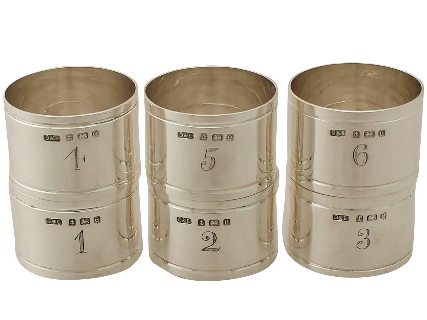 An exceptional, fine and impressive set of six numbered antique Edwardian English sterling silver napkin rings - boxed; an addition to our dining silverware collection.

This exceptional set of antique Edwardian silver napkin rings in sterling