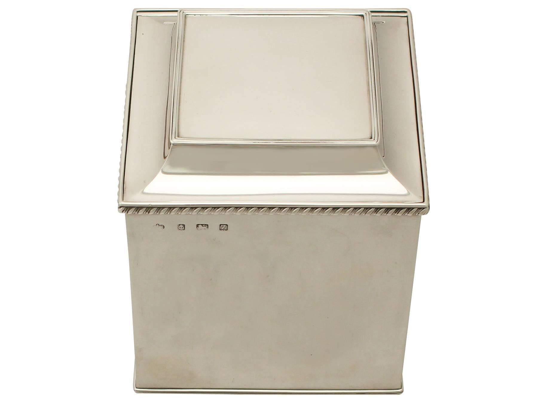 An exceptional, fine and impressive antique George V English sterling silver biscuit box; an addition to the ornamental silverware collection.

This exceptional antique sterling silver biscuit box has a plain cuboid form.

The surface of this