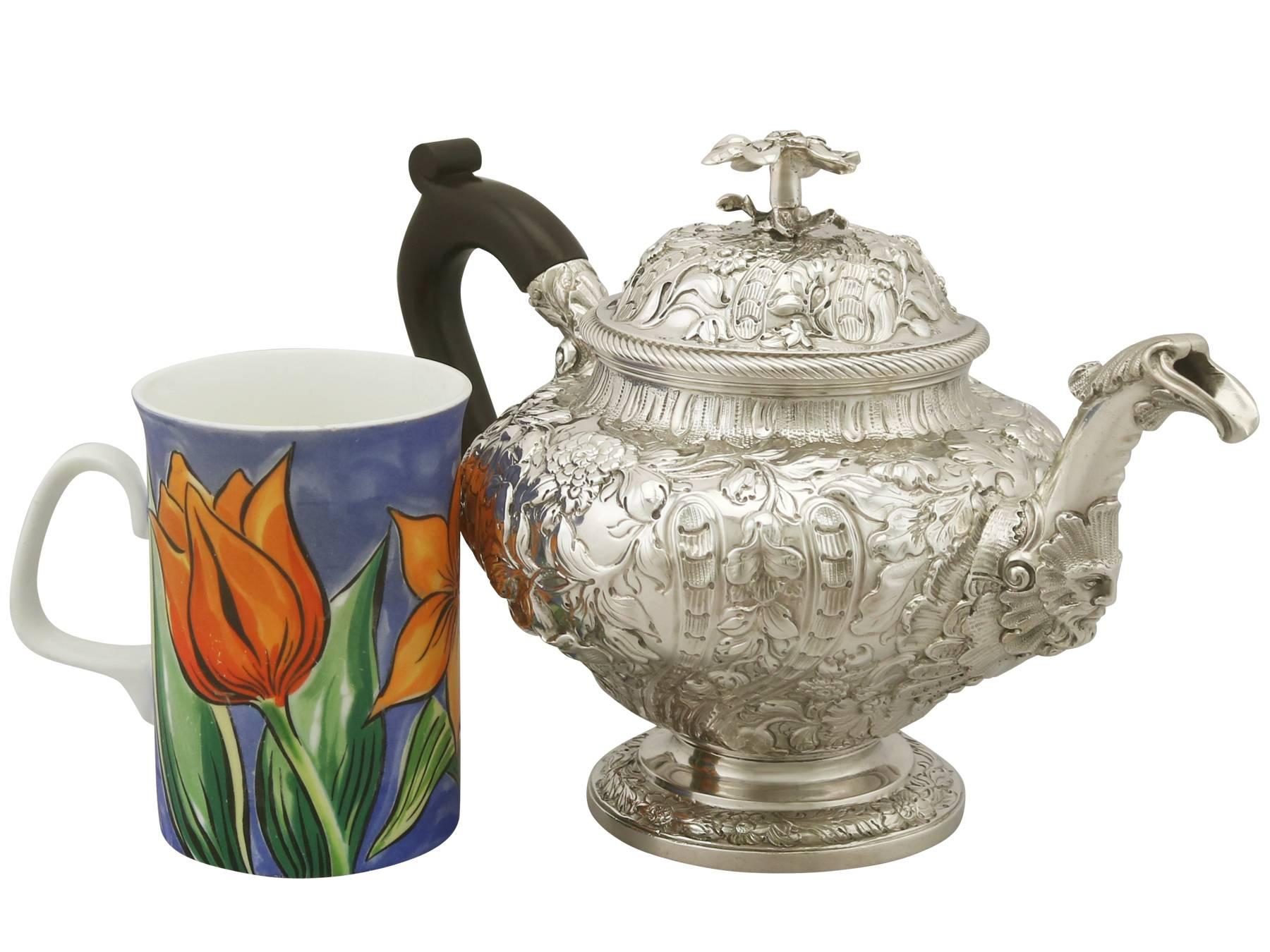 An exceptional, fine and impressive antique George III English sterling silver teapot; an addition to our Georgian silver teaware collection.

This exceptional antique George III English sterling silver teapot has a circular rounded form onto a