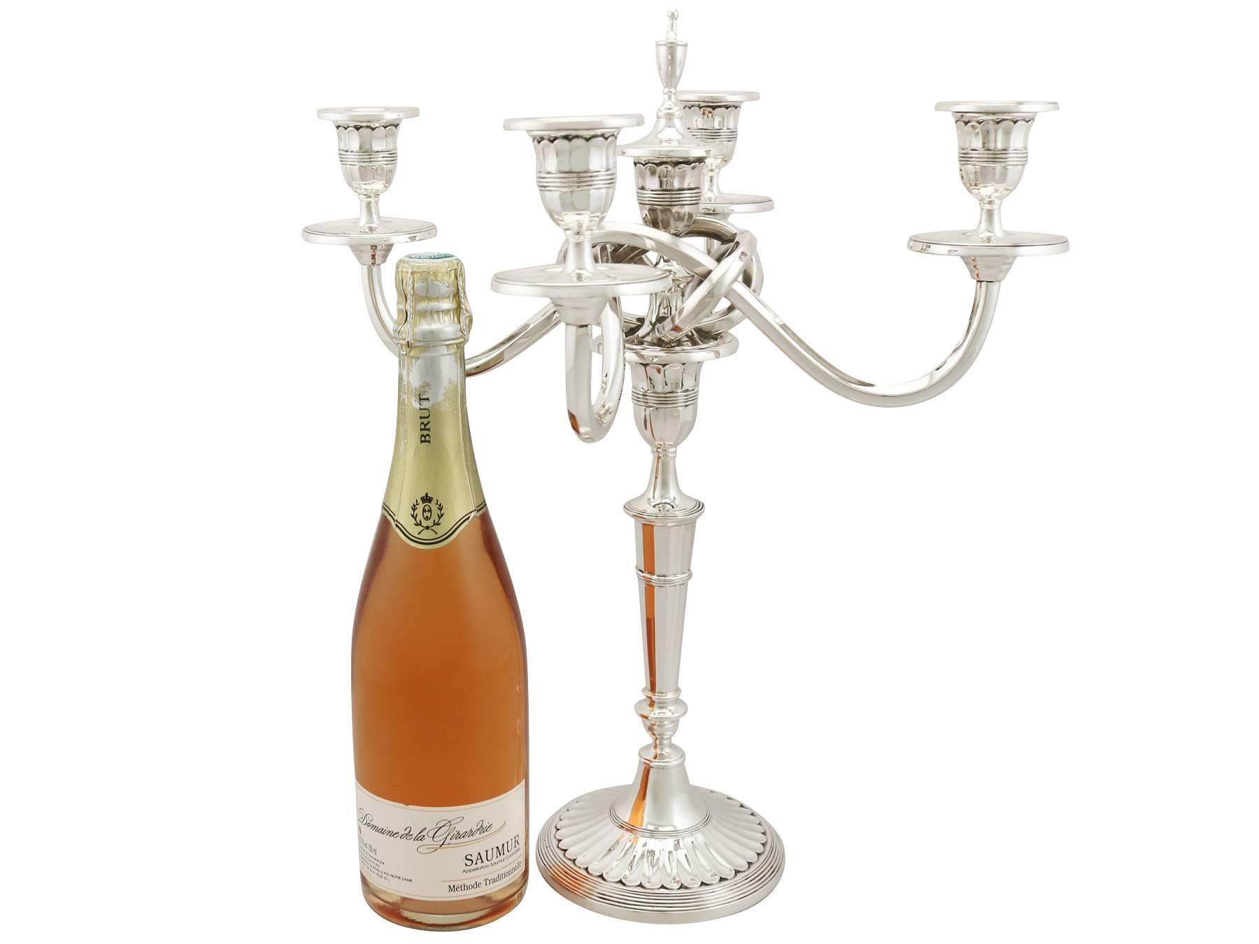 An exceptional, fine and impressive pair of Portuguese 916 standard silver candelabra; an addition to our ornamental continental silverware collection.

These exceptional vintage cast Portuguese silver five light candelabra have plain bell shaped
