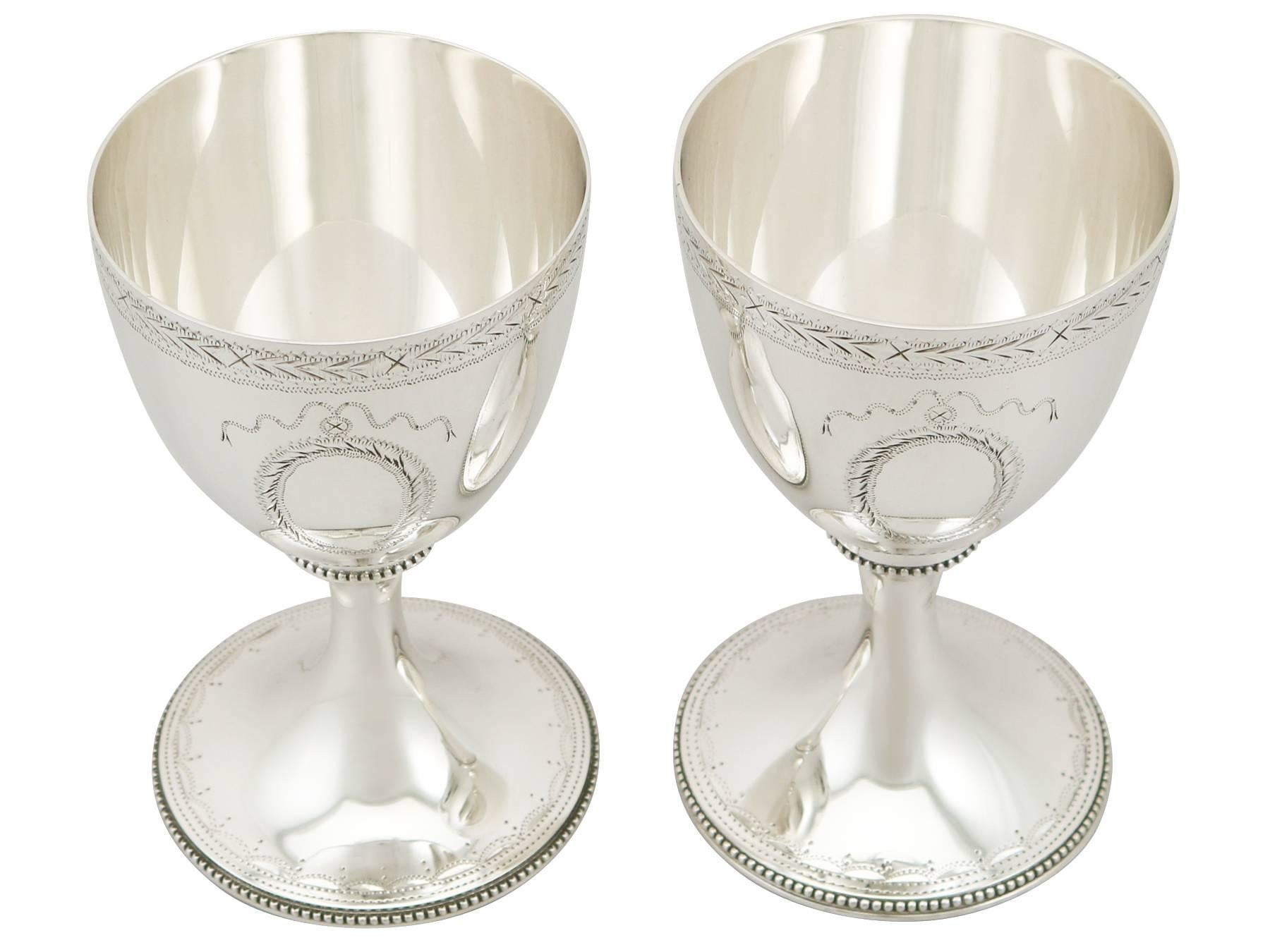 An exceptional, fine and impressive pair of vintage English sterling silver goblets; an addition to our range of wine and drink related silverware.

These exceptional vintage Elizabeth II sterling silver drinking goblets have a plain circular bell