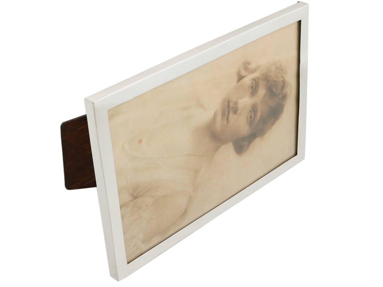 An exceptional, fine and impressive antique George V English sterling silver photograph frame; an addition to our collection of ornamental silverware.

This exceptional antique George V sterling silver photograph frame has a plain rectangular