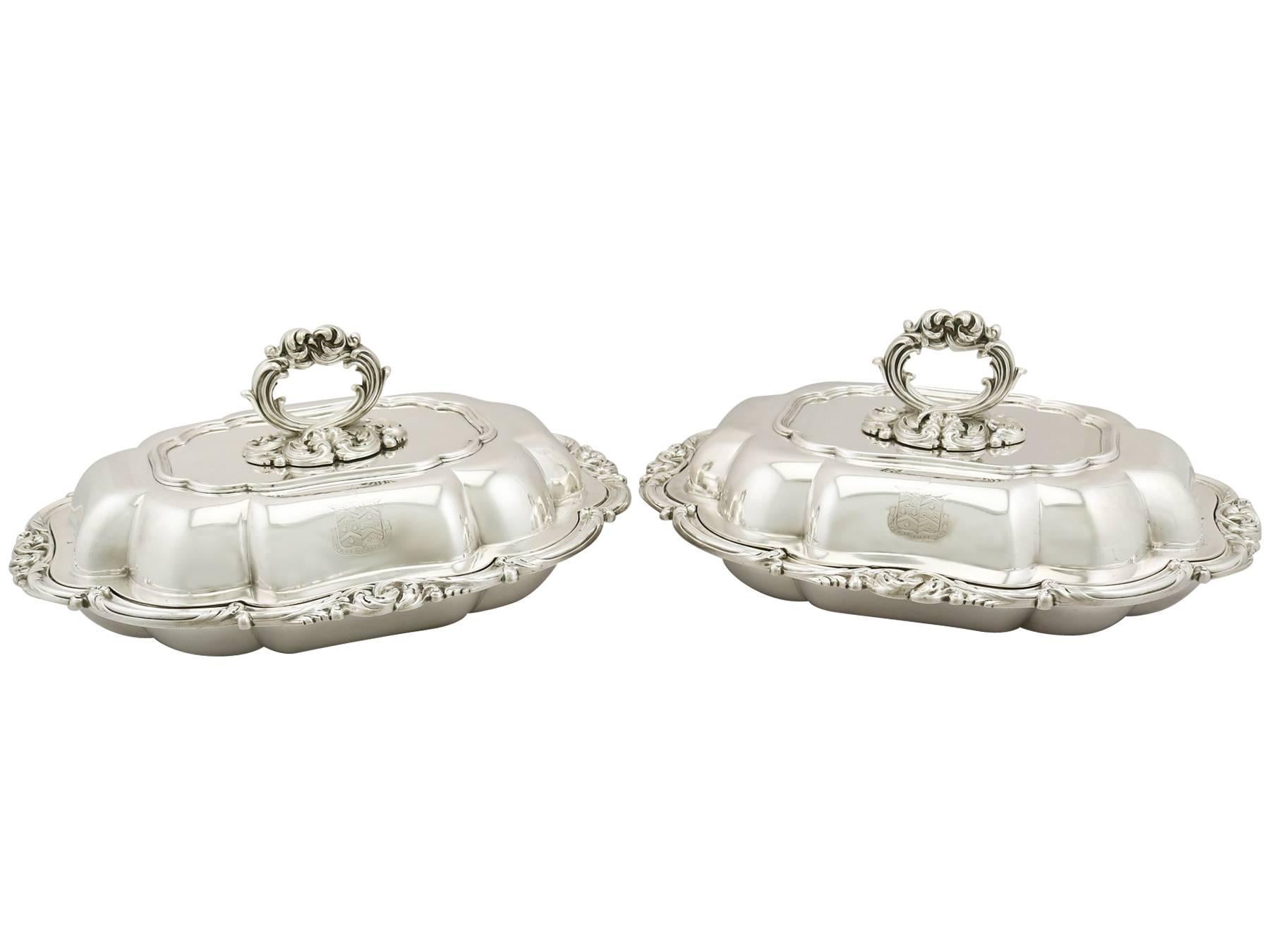 An exceptional, fine and impressive pair of antique William IV English sterling silver entree dishes; an addition to our ornamental dining collection.

These exceptional antique William IV sterling silver entrée dishes have an oval shaped