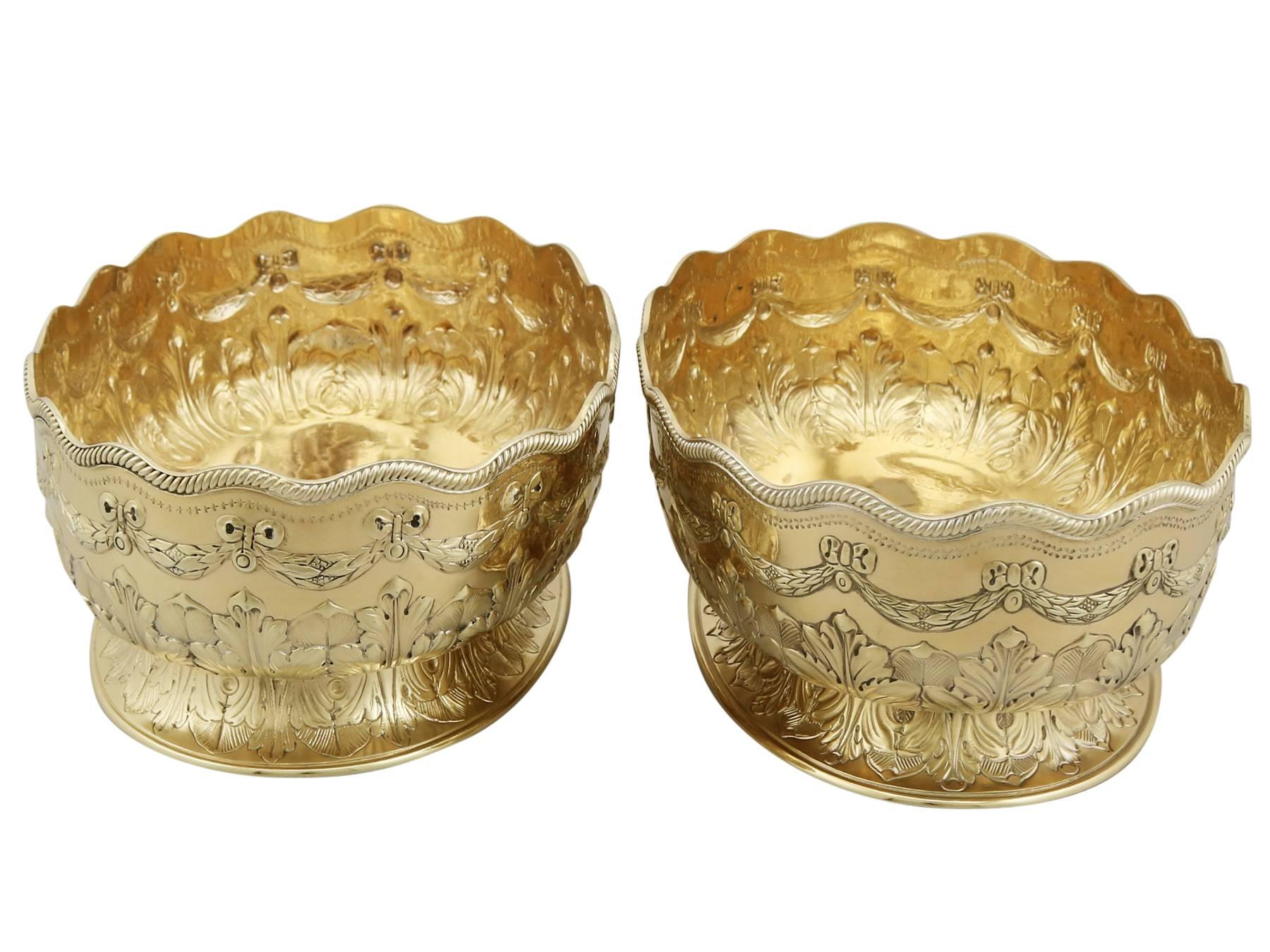 An exceptional, fine and impressive pair of antique Victorian English sterling silver gilt presentation dishes; part of our presentation silverware collection.

These exceptional antique Victorian English sterling silver bowls have an oval form
