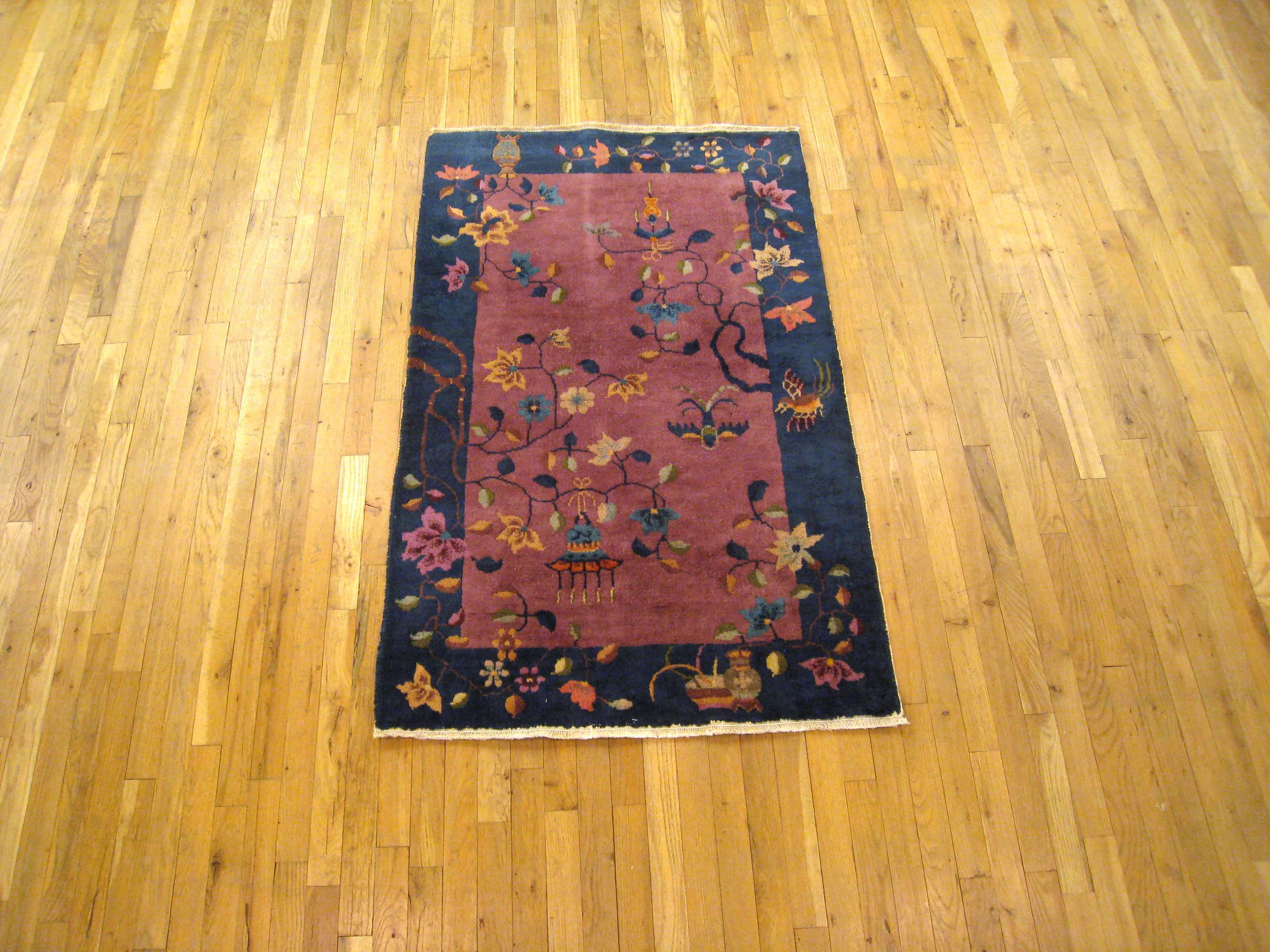 An antique Chinese Art Deco oriental rug, size 5'0 x 3'0, circa 1920. This lovely hand-knotted antique carpet features various Chinese motifs in the delightful central field, enclosed within a handsome outer border. Hand-made, with short to medium