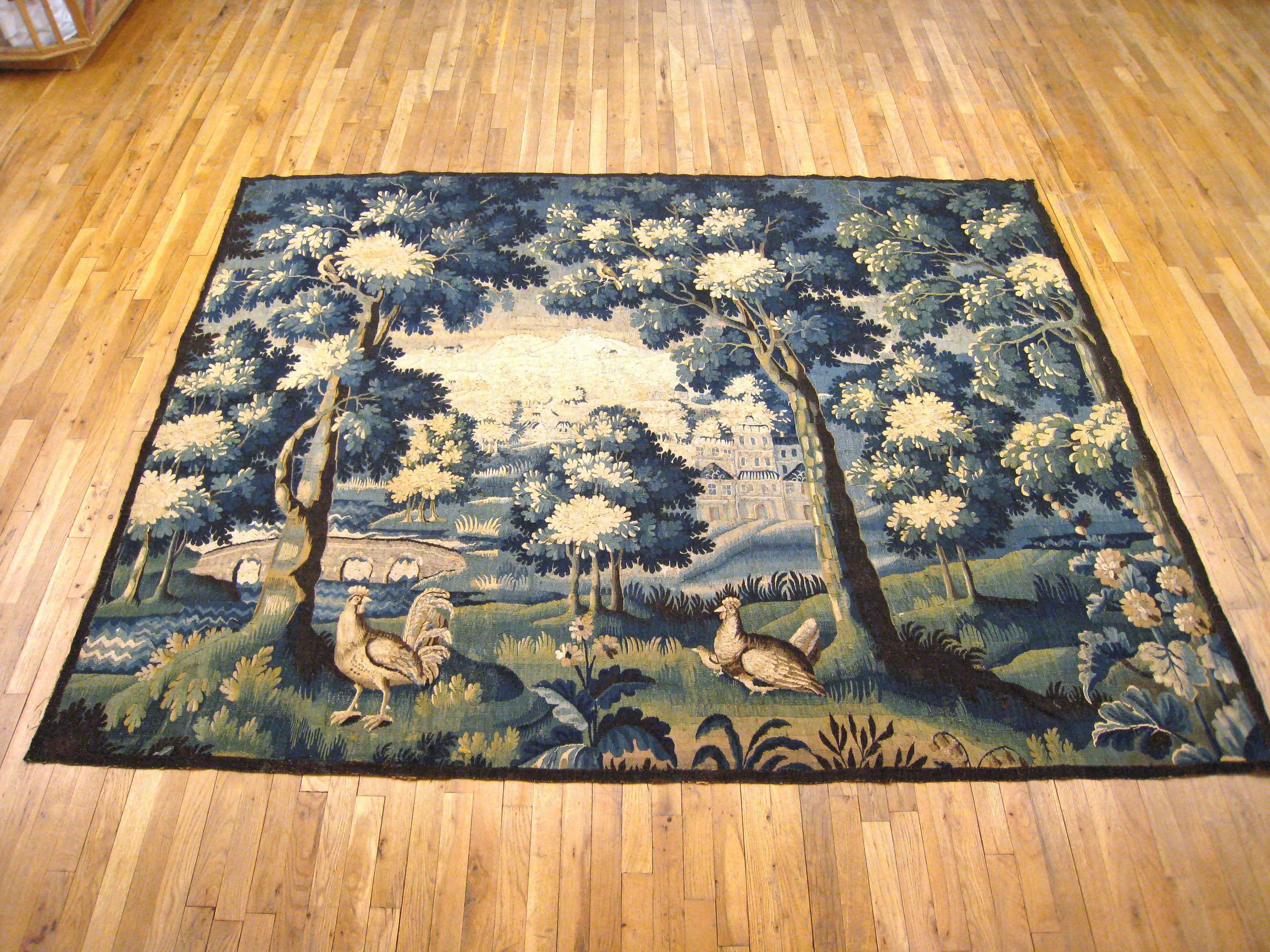 An antique 18th century Flemish verdure landscape tapestry, size 6'9