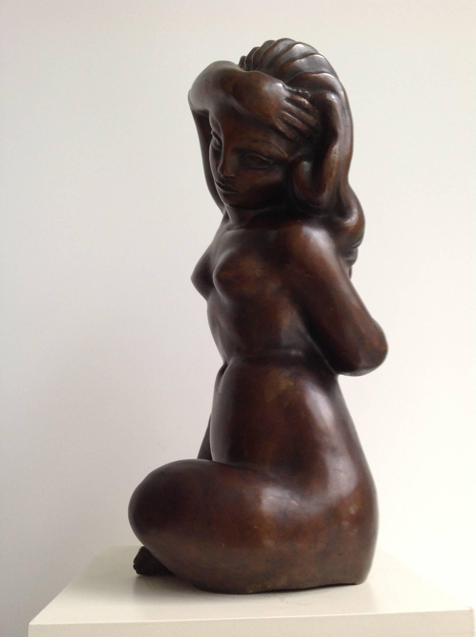 Remarkable sculpture of a female nude with long hair putting her right arm over her head and her left arm behind her back.