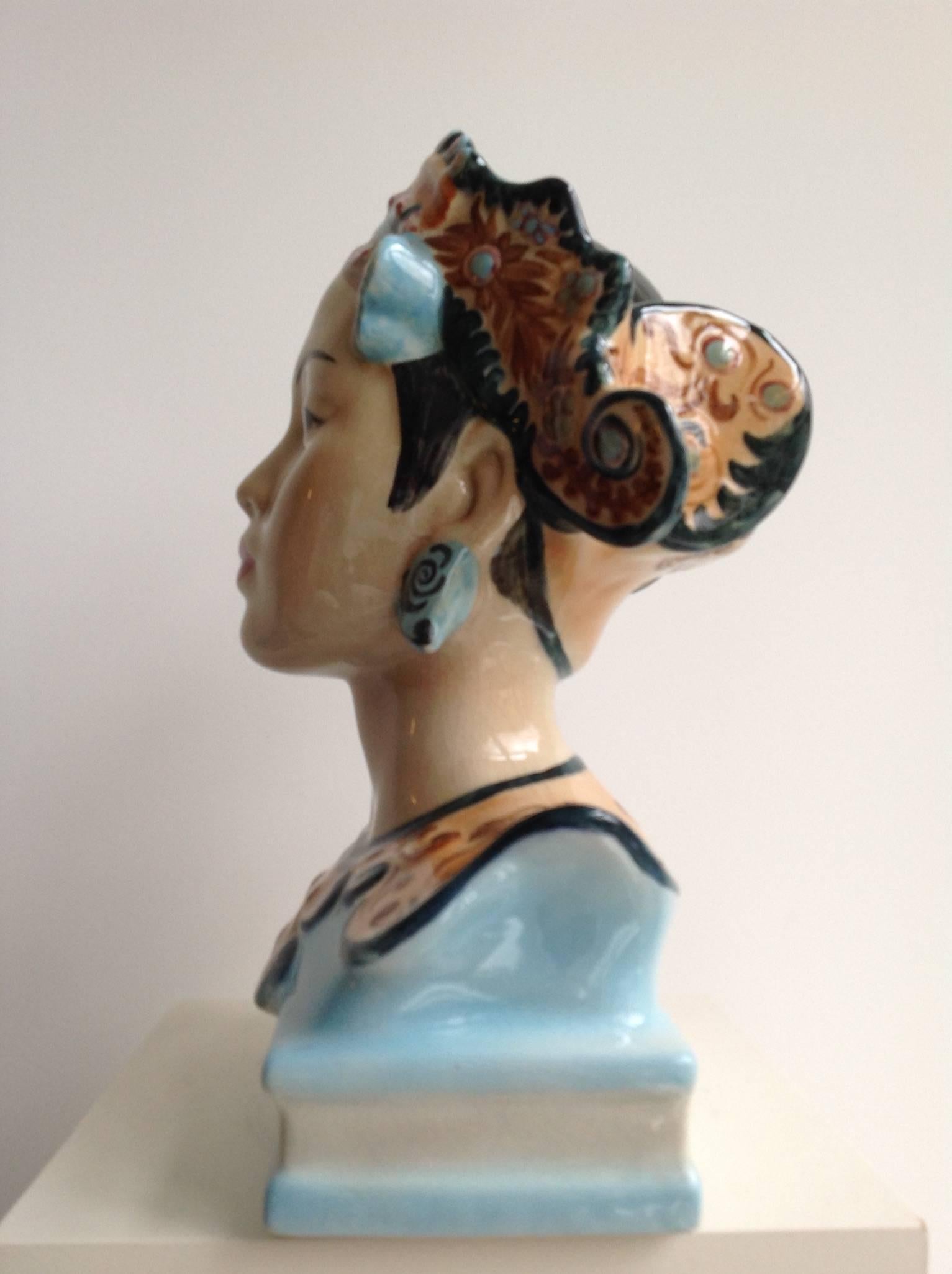 A highly decorative pottery bust of a Balinese dancer in striking colours by the designer Helen Liedloff, who named it 