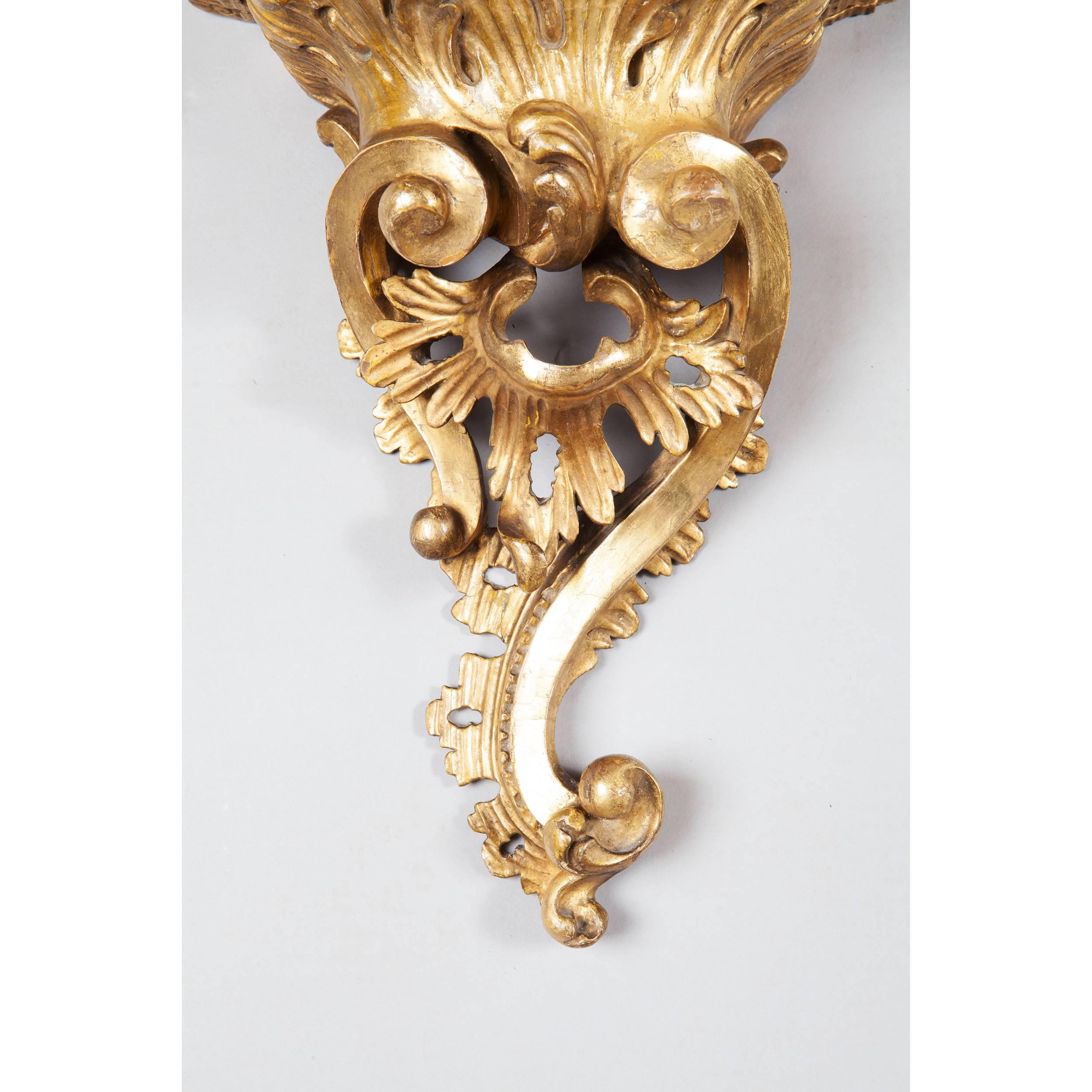 A fine mid 18th-century George III giltwood Rococo wall bracket, with asymmetrical scrolling detail and pierced foliage. 

Measures: Height 14 inches,
width 10 inches,
​depth 6 1/2inches.