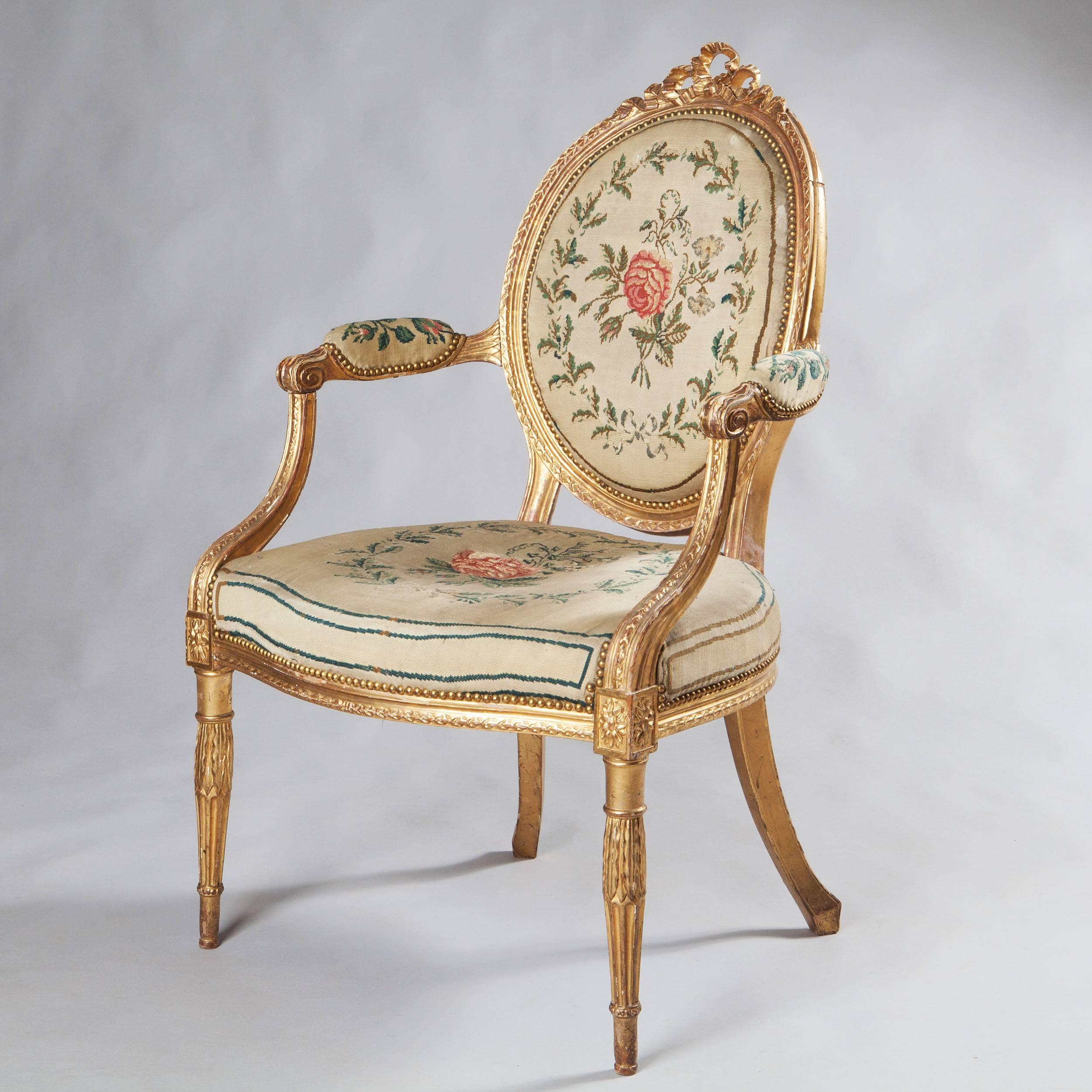 England, circa 1780.

A very fine late 18th-century suite of six armchairs and a settee, of elegant design and good proportions, the oval backs with ribbon detailing, out-swept arms and raised on tapering fluted legs. All retaining their original