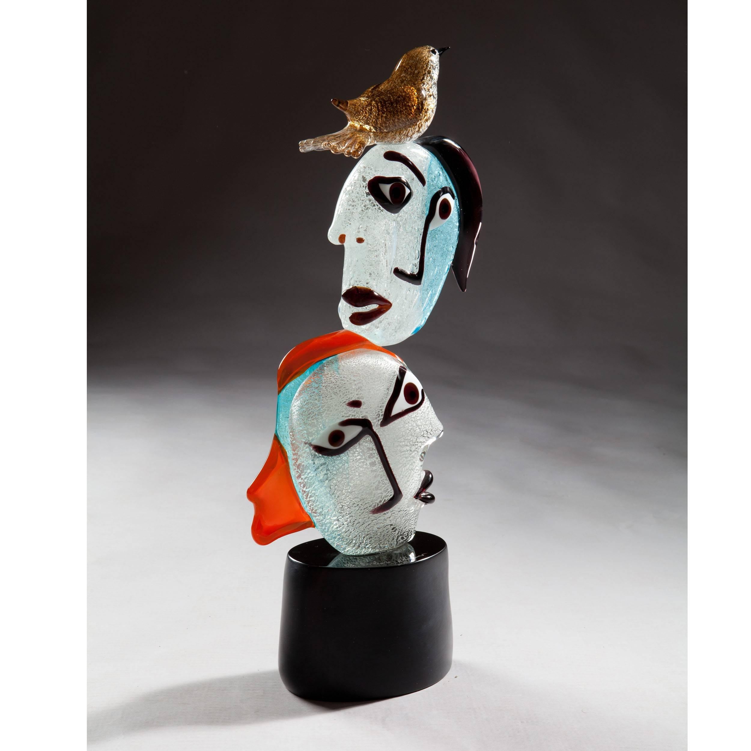 Italy, Modern.

A fine Murano figurative glass group of two opposing heads with a bird seated on top, in homage to Picasso. 

Measures: H 21 1/2in 55cm,
W 10in 26cm,
D 4in 10cm.