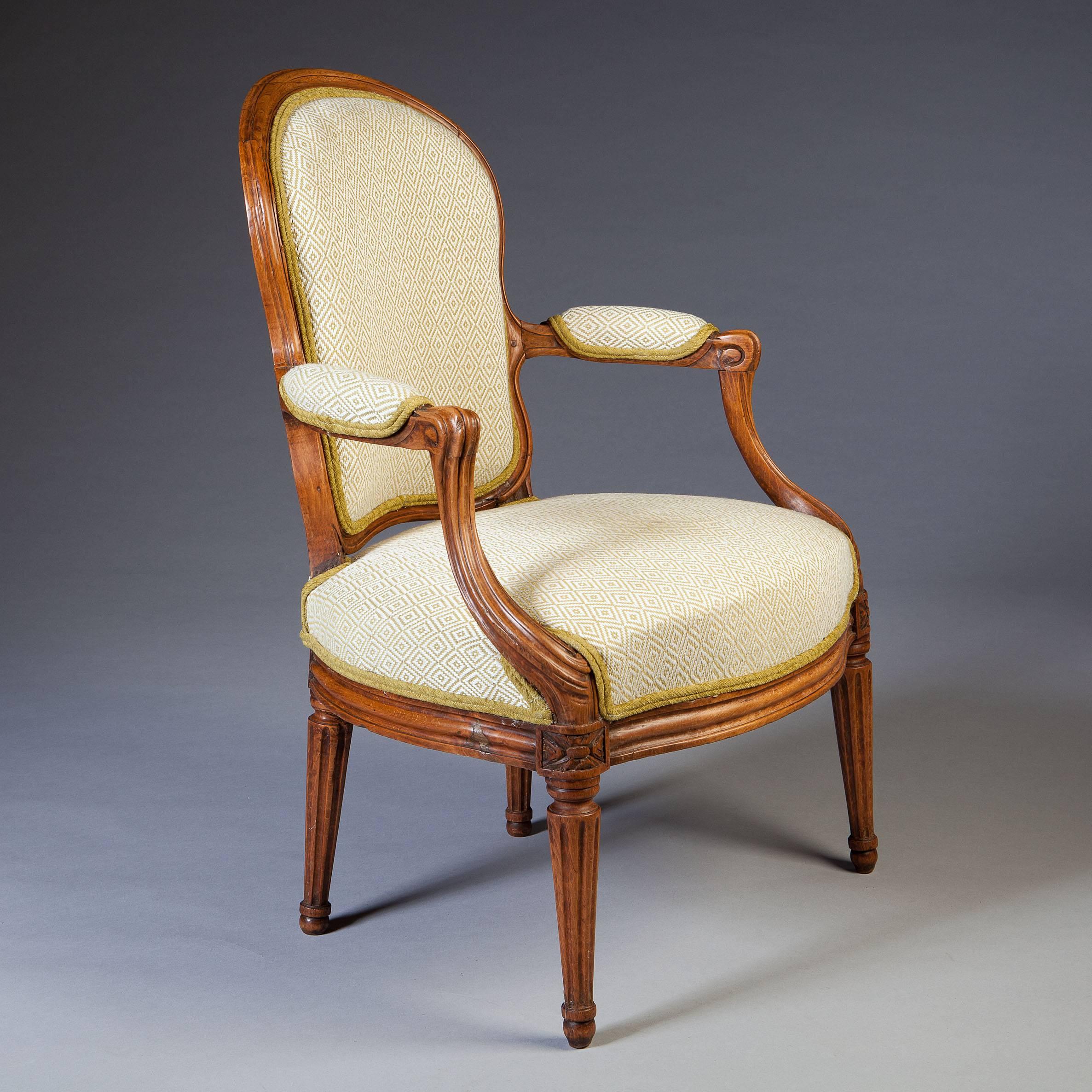 France, circa 1770.
​
A charming pair of late Louis XV period fauteuils, the kidney shaped backs of simple outline supported on neoclassical fluted tapering legs. Each armchair stamped on the rails N.S.Courtois (Nicolas Simon Courtois master 1766
