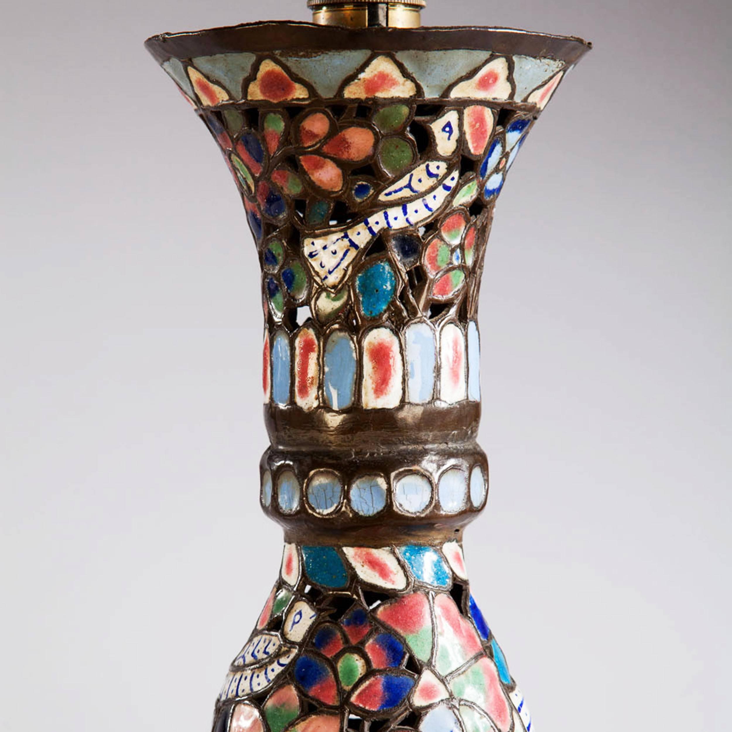 Moorish, circa 1900.

A fine and large pair of pierced and enamelled lamp bases decorated with birds and foliage in vivid colours of blue, pink, green and white with panels of script. 

Measures: Height 79.00cm (31 inches).
Diameter 33.00cm (13