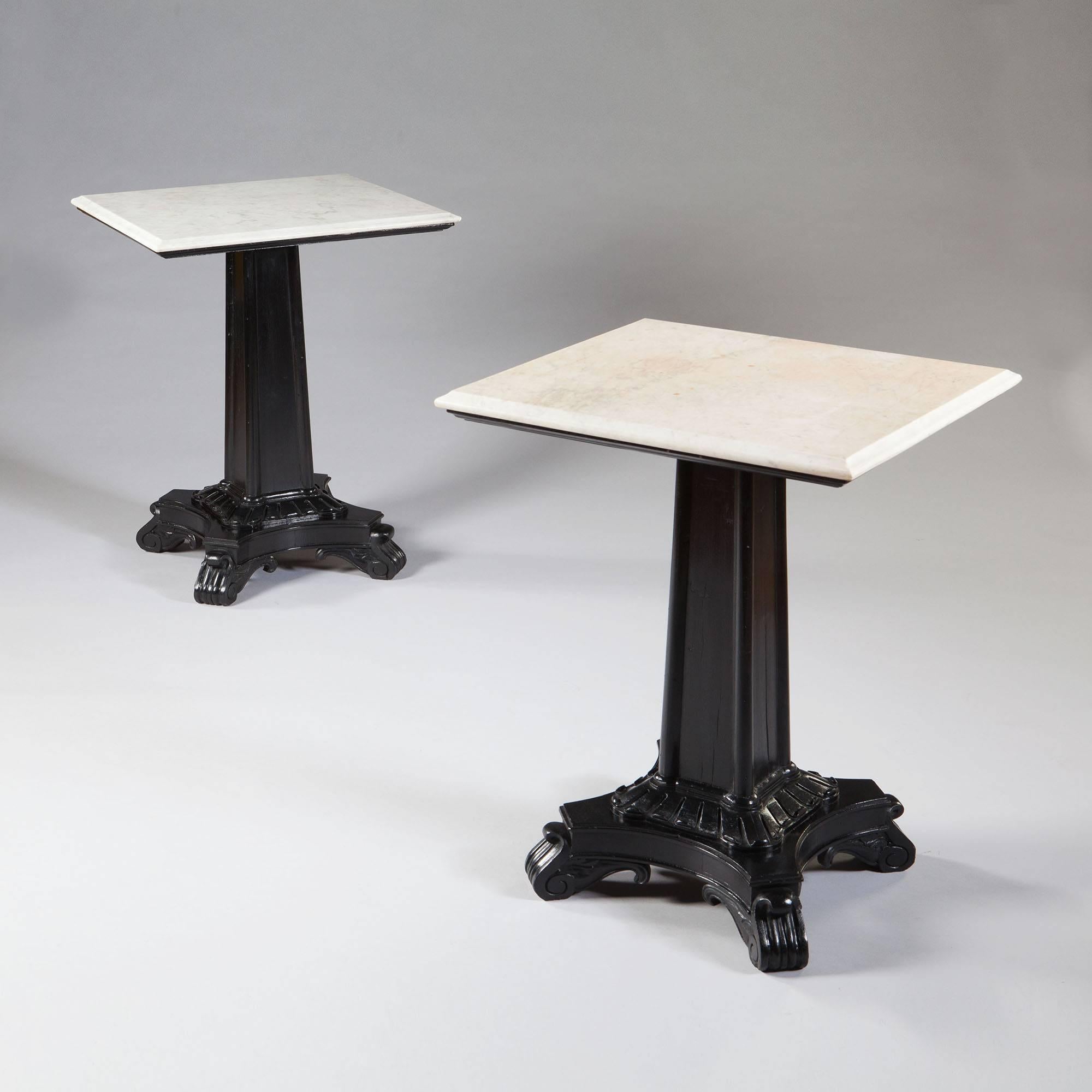 A pair of late 19th century ebonized end tables with nearly square marble tops. The bases are columns with stylized scrolls to the base and standing on concave sided plinths terminating in scroll feet,

India, circa 1880.
Measures:
Height 30 ins