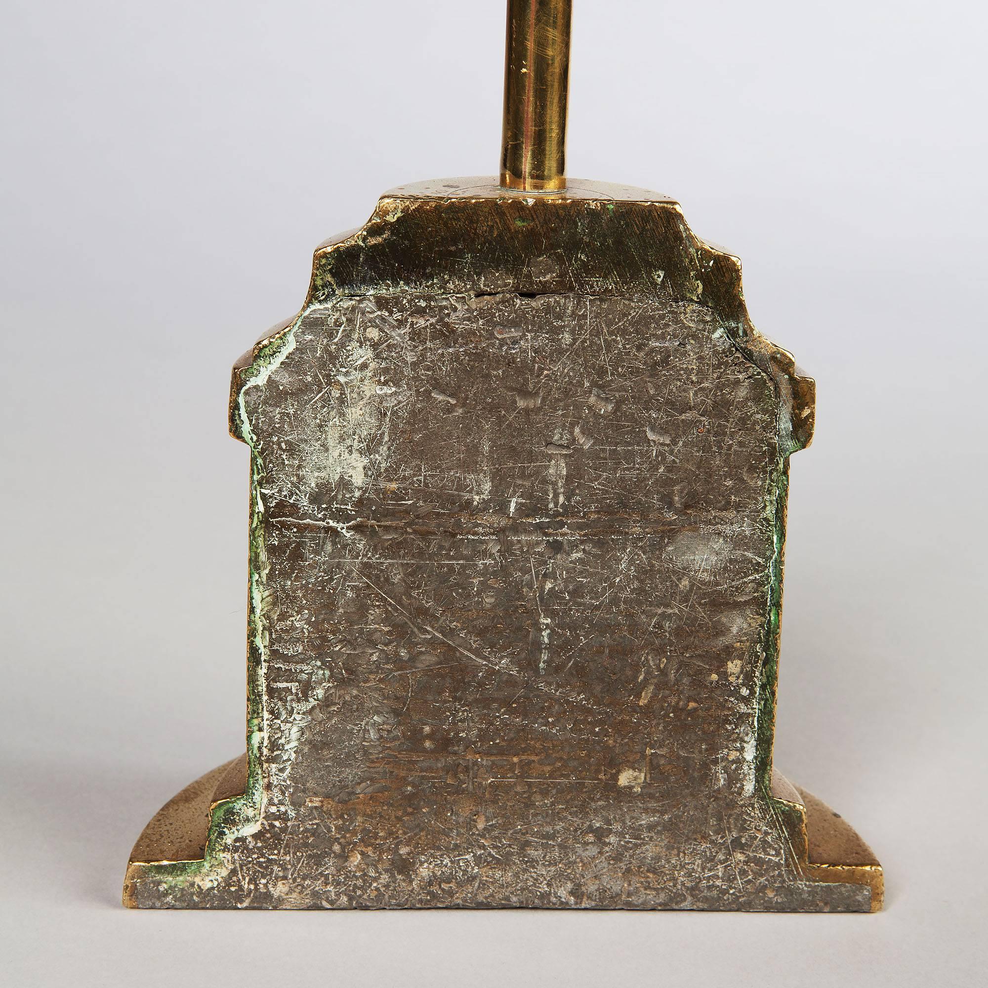 England, circa 1810.

A Regency overscale tall brass dado rail height door stop. The tall brass stem has an oval ring handle above a half bell shaped base - weighted with lead. 

Measures: Height 29 in (74 cm).
