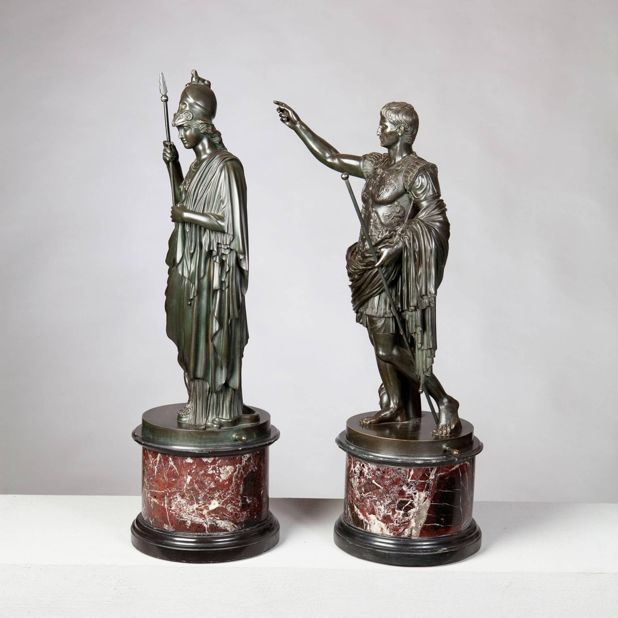 A pair of fine 19th-century bronze statues of Minerva and the Roman Emperor Augustus, both finely cast and patinated with a slight green tone. Both raised on their original rouge marble bases. 

Height including plinth 26in.
​Diameter