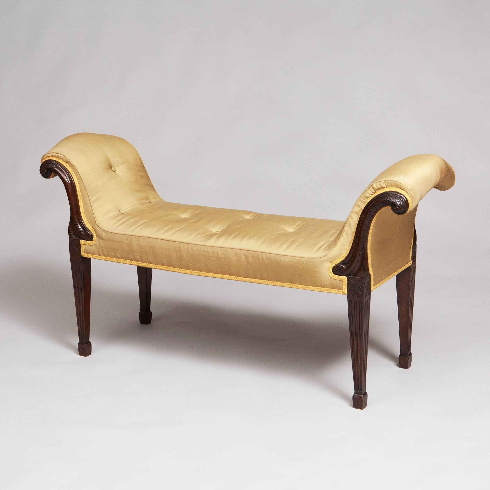 England, circa 1770.
​
The acanthus-carved scroll ends above a straight seat rail on stop fluted tapering legs headed by paterae.

Measures: Width 48in,
height 25in,
seat height 16in.
​Depth 15 3/4in.