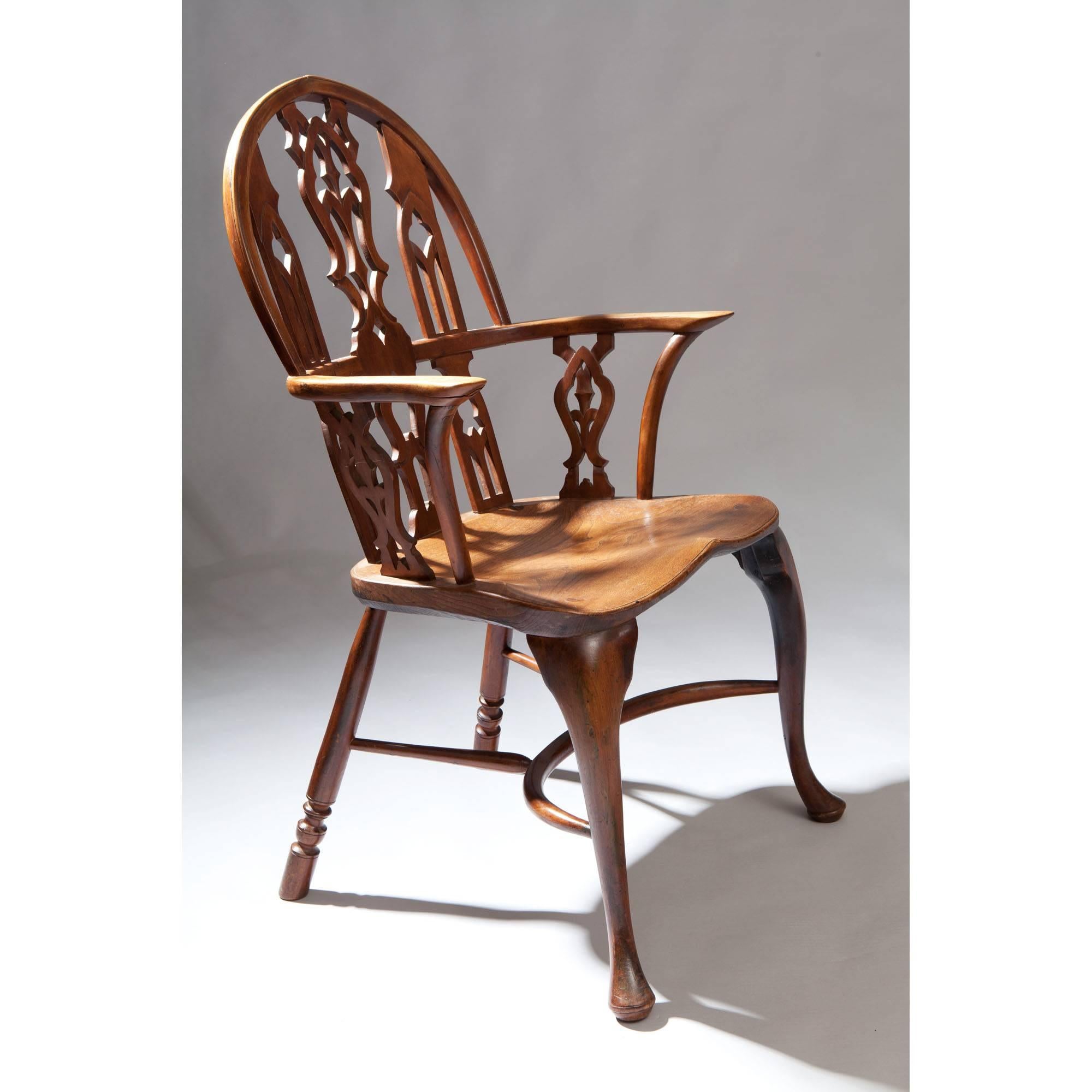 A fine pair of Gothic elm and yew wood windsor chairs.