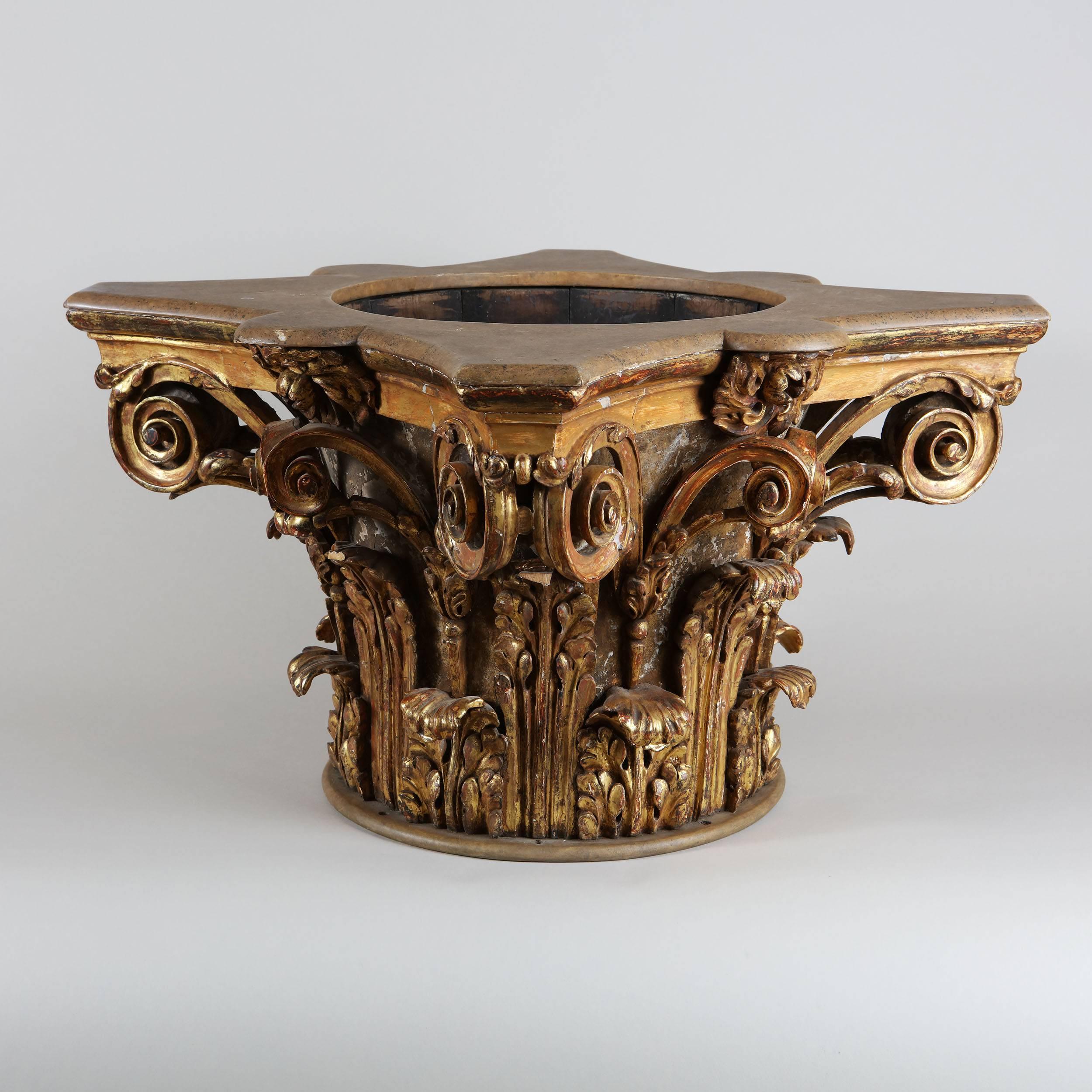 A very fine 19th century carved and giltwood Corinthian capital, richly carved with acanthus leaves and scrolling volutes, the top with a recess and central brass liner with ring handles.
