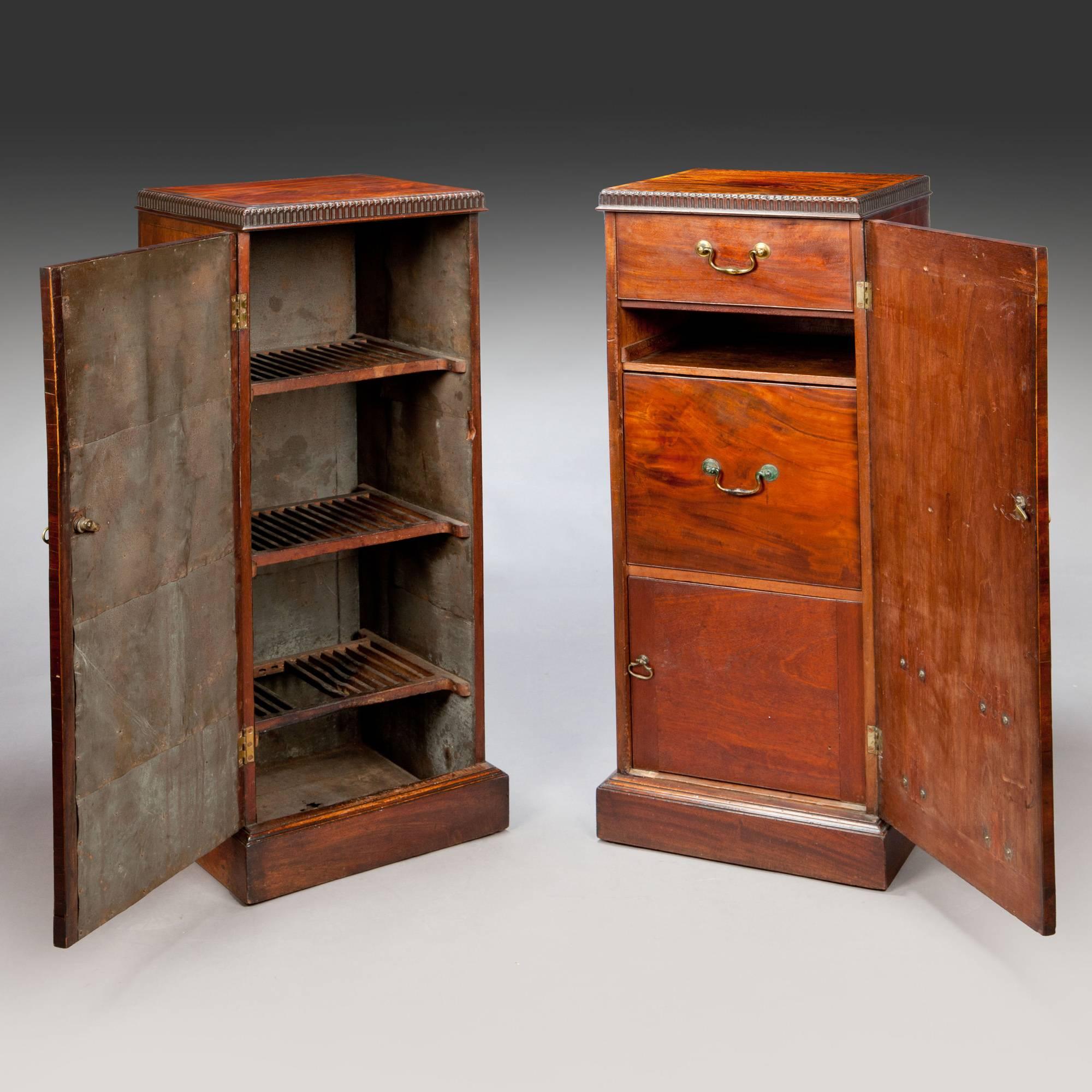 England, circa 1780.

​A fine pair of George III dining room mahogany pedestal cupboards, each with highly figured panels of mahogany veneer within feather banding, opening to warming shelves and fitted drawers.

Measures: Height 44in.
Width