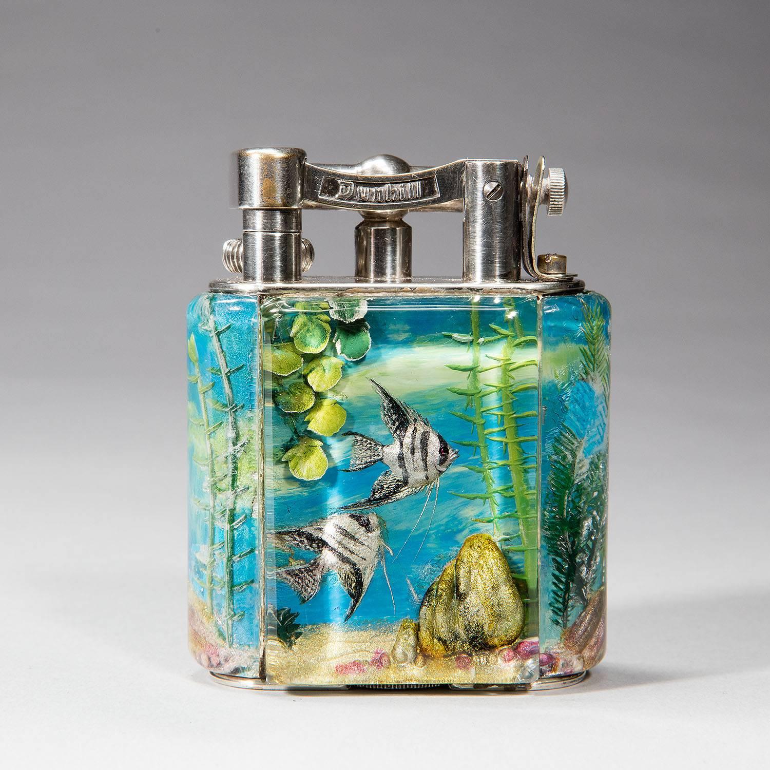 For your consideration, a Dunhill Aquarium lighter made in the mid 50’s. All Dunhill Aquarium lighters are one of a kind as they are hand-painted with aquatic scenes on each of their four sides. The sides are made of Perspex a material similar to