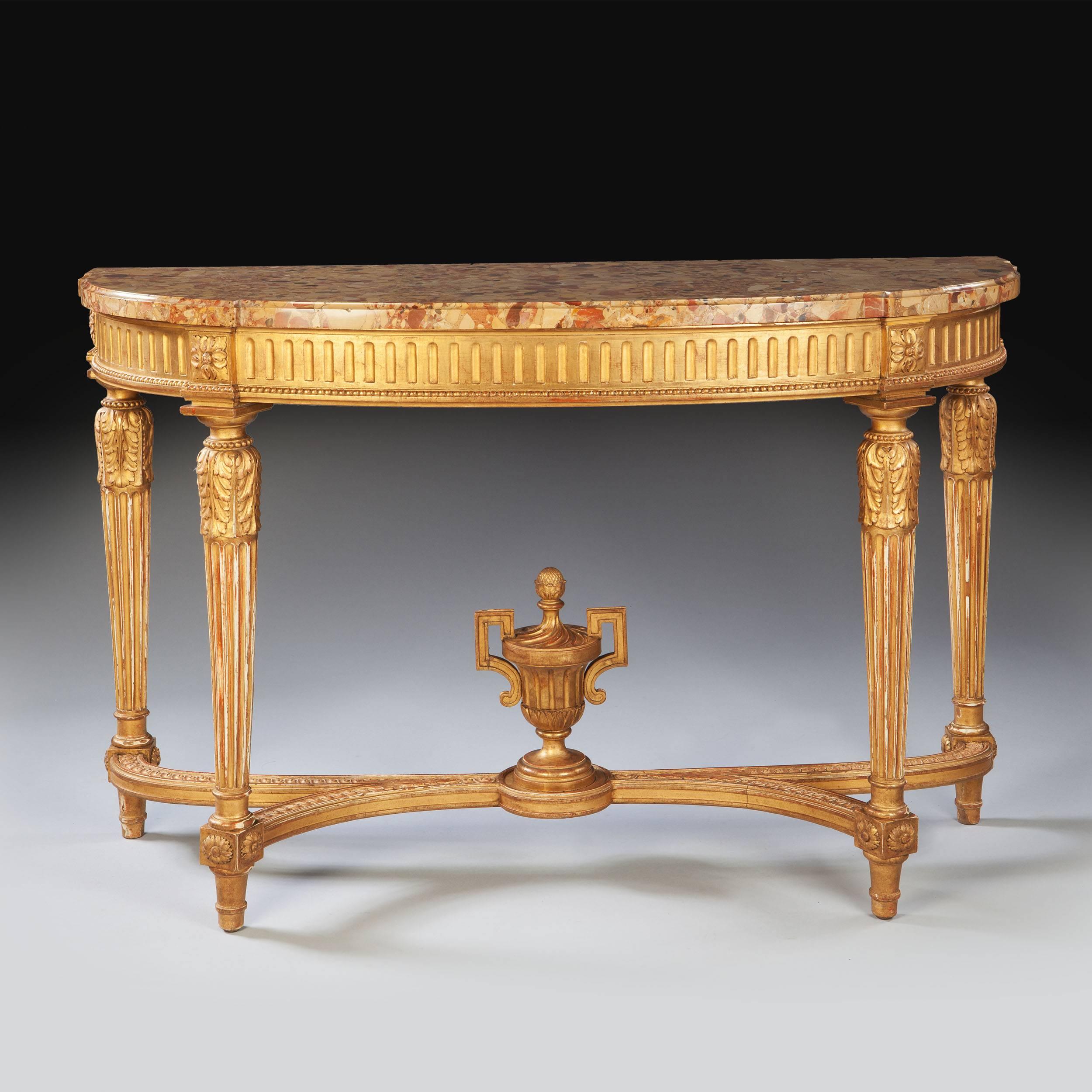 France, 1913.

A fine early 20th century neo classical giltwood gold console table, the D-shaped Breche d'Alep marble top above a fluted frieze with paterae and acanthus ornament, the fluted tapering legs joined by an X-stretcher with a central