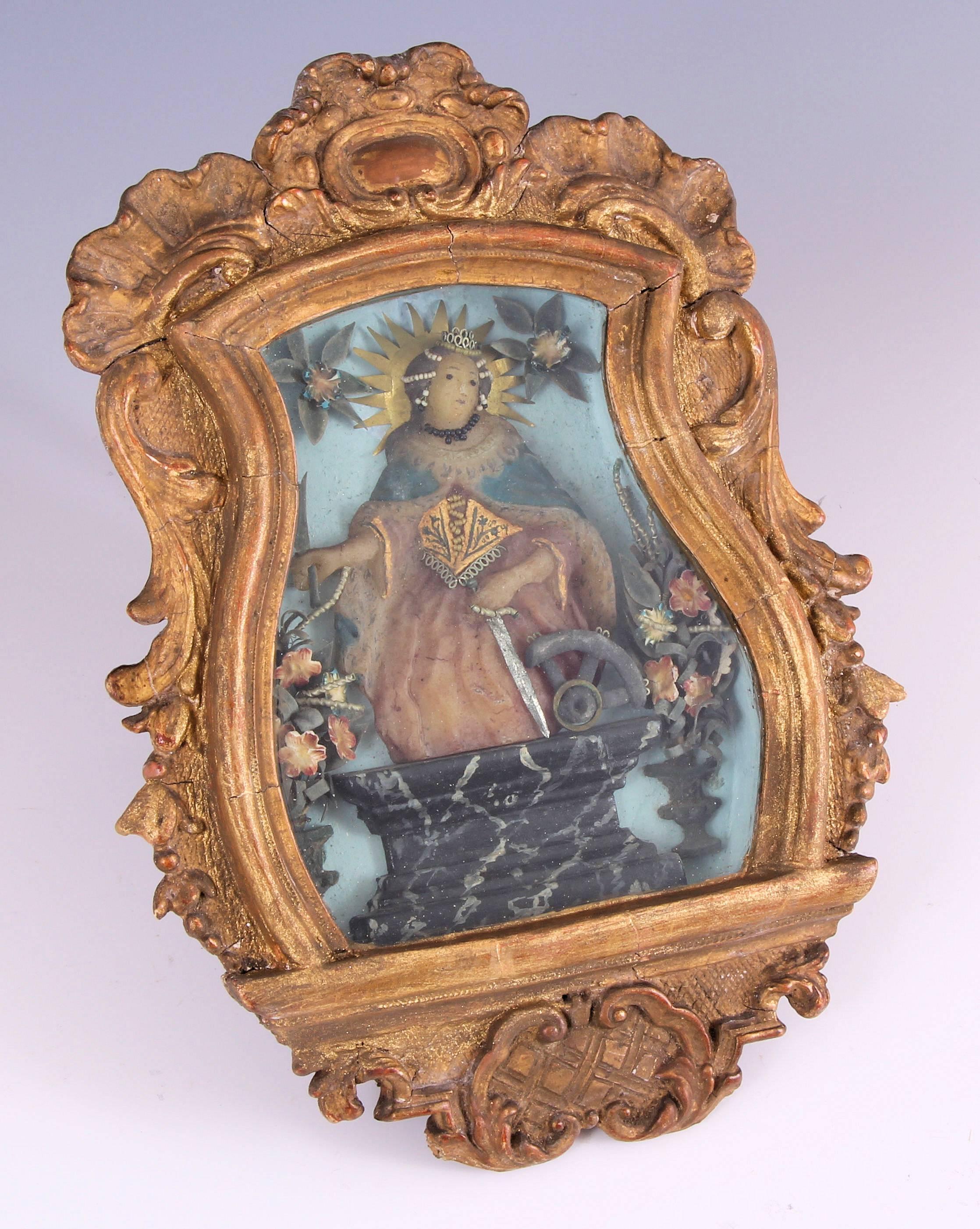 Rare 18th century giltwood framed carved and polychrome wax silver and gold decorated figure of saint Catherine of Alexandria icon, with original gilt frame. The rarity of this piece cannot be overstated. This incredible piece is museum quality and