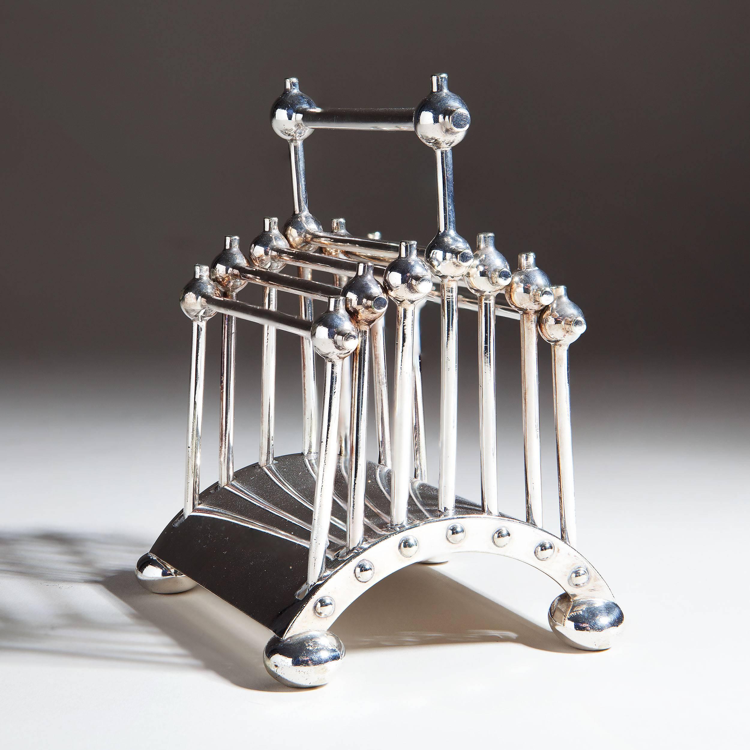 A Hukin and Heath articulated letter rack designed by Dr Christopher Dresser, model no.2555, rod and ball construction on arched base, stamped marks, silver plate. 

Measures: 12.5cm high.
​
Literature:
Michael Whiteway Dr Christopher Dresser,