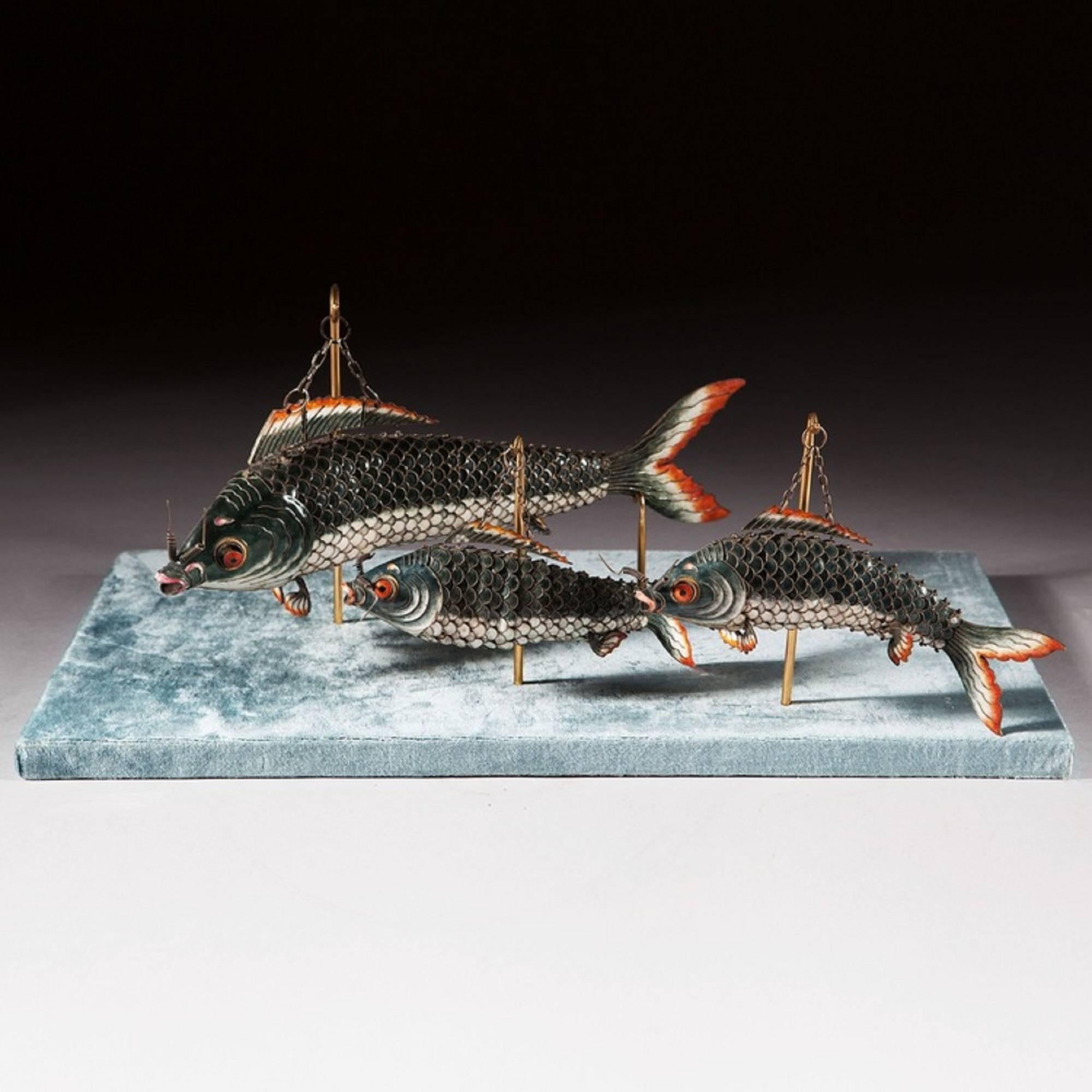 A set of three Chinese export articulated enamel models of fish. Each rendered in Fine detail and articulating in the most extravagant fashion, 

China, circa 1900.

The largest fish 14 ins (36 cms).

Dimensions noted on this listing are an
