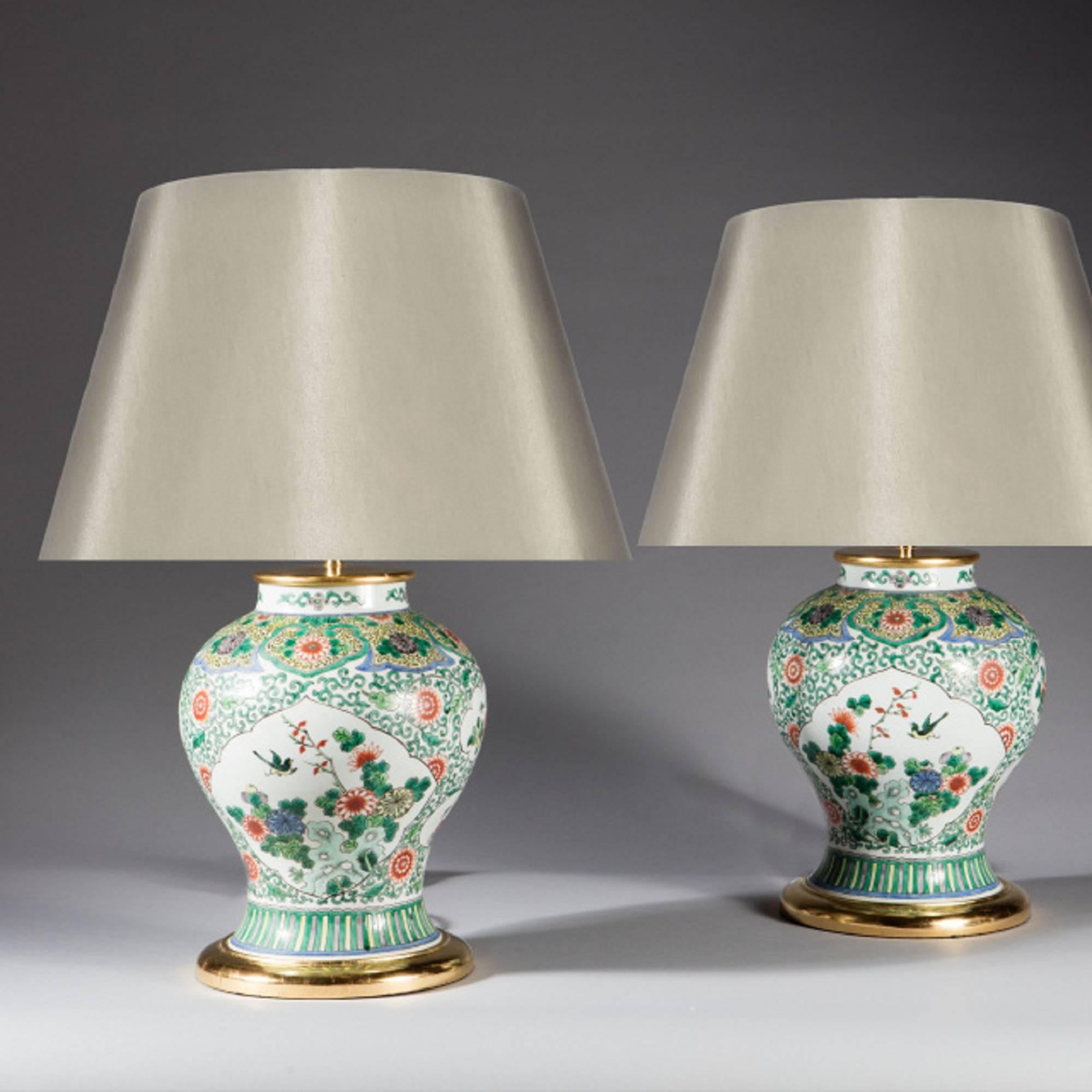 A pair of Chinese export famille verte baluster vases, decorated in fine detail with flowers and branches and architectural vignettes.

China, circa 1850

Measures: Height excluding shade Height 15 ins (38 cm).

 