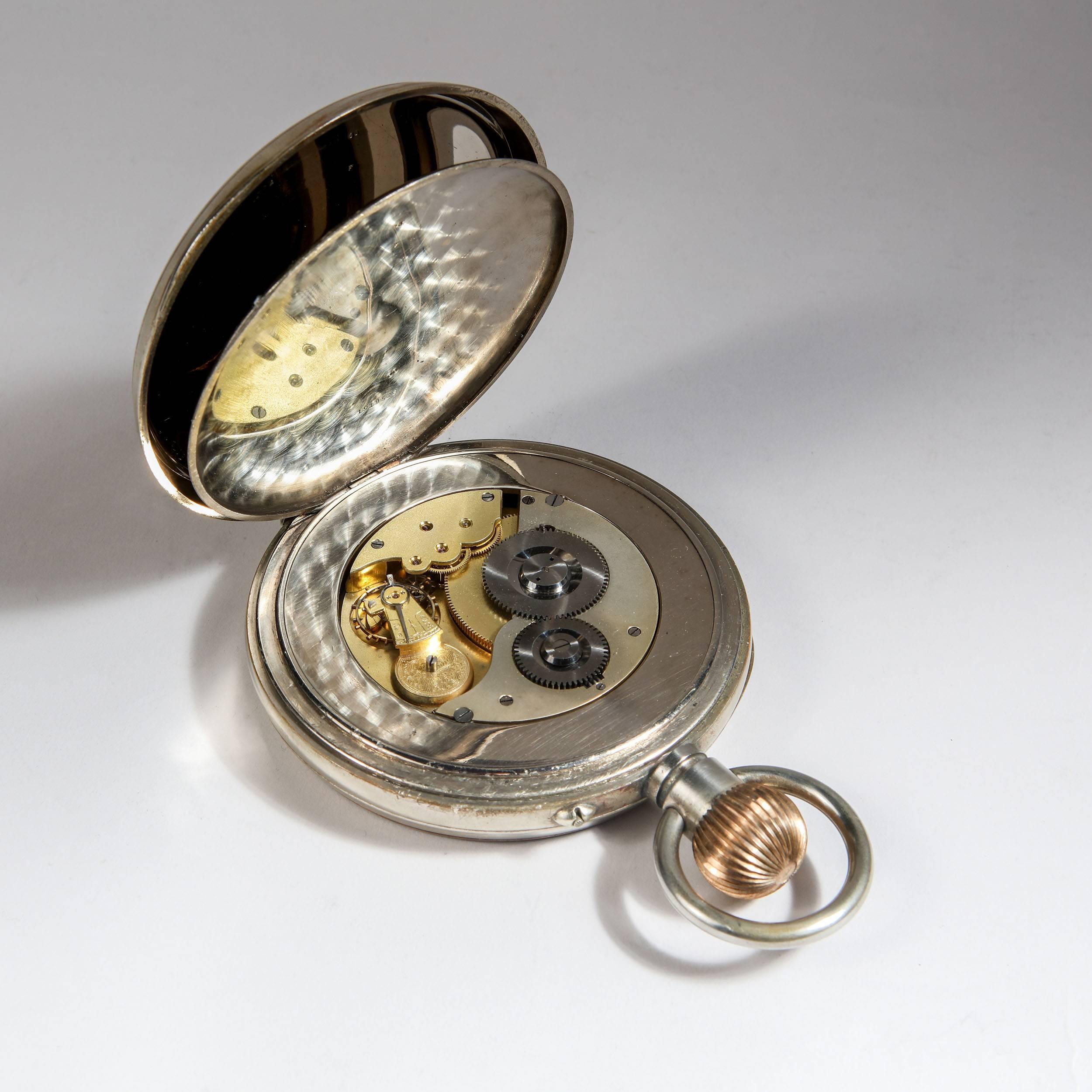 A giant pocket watch of exceptional scale, the watch movement mounted within its original solid silver and leather case with open face and hinged stand at the back.

Silversmith: William Comyns & Sons Ltd, London, 1906

Measures: The watch case