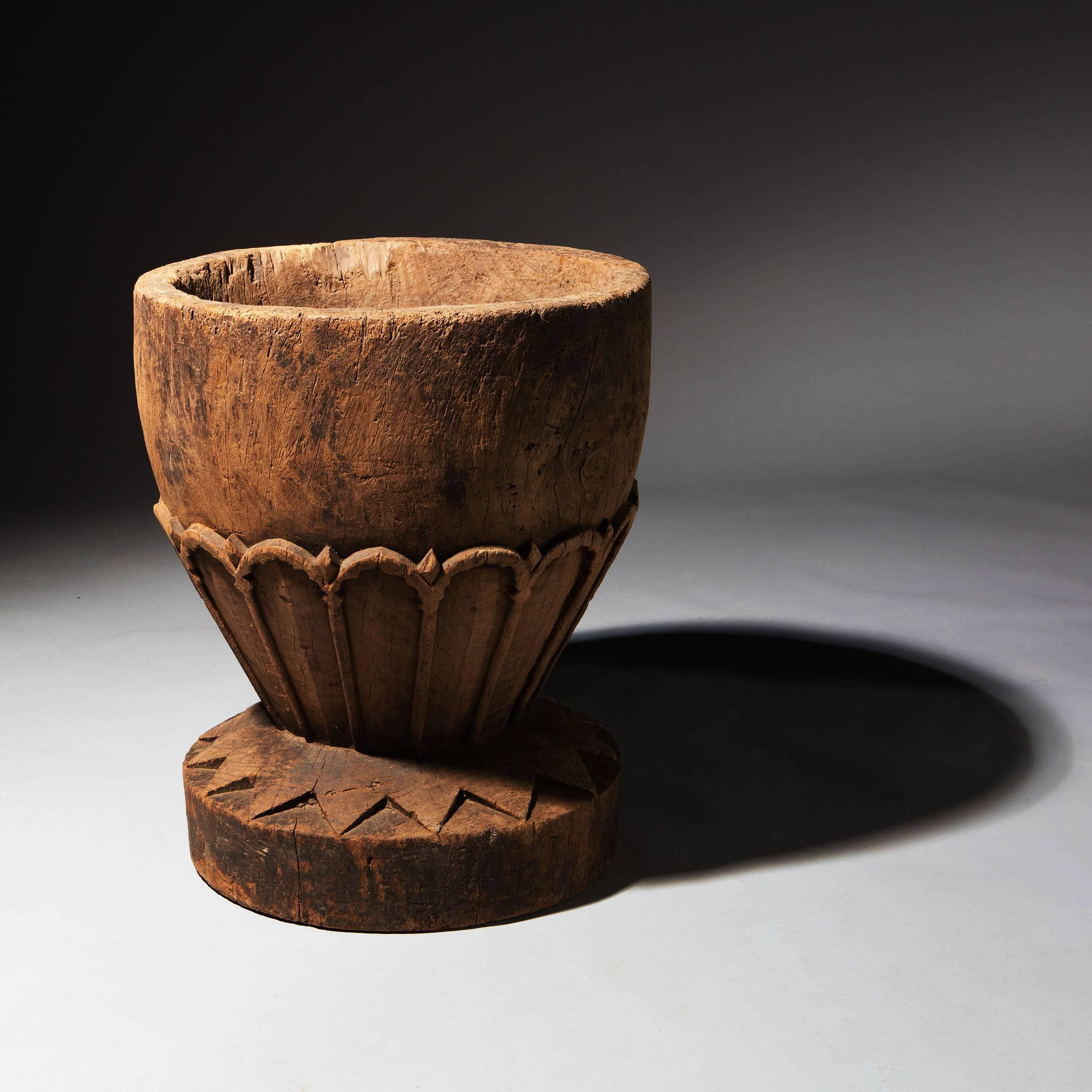 Indian, 19th century

A large-scale wooden mortar with chevron ornament carved in high relief base and petal ornament to the bowl. The fabulous object is rich with character in the wood itself and its overall condition. 

Measures: 18.5in, 47cm