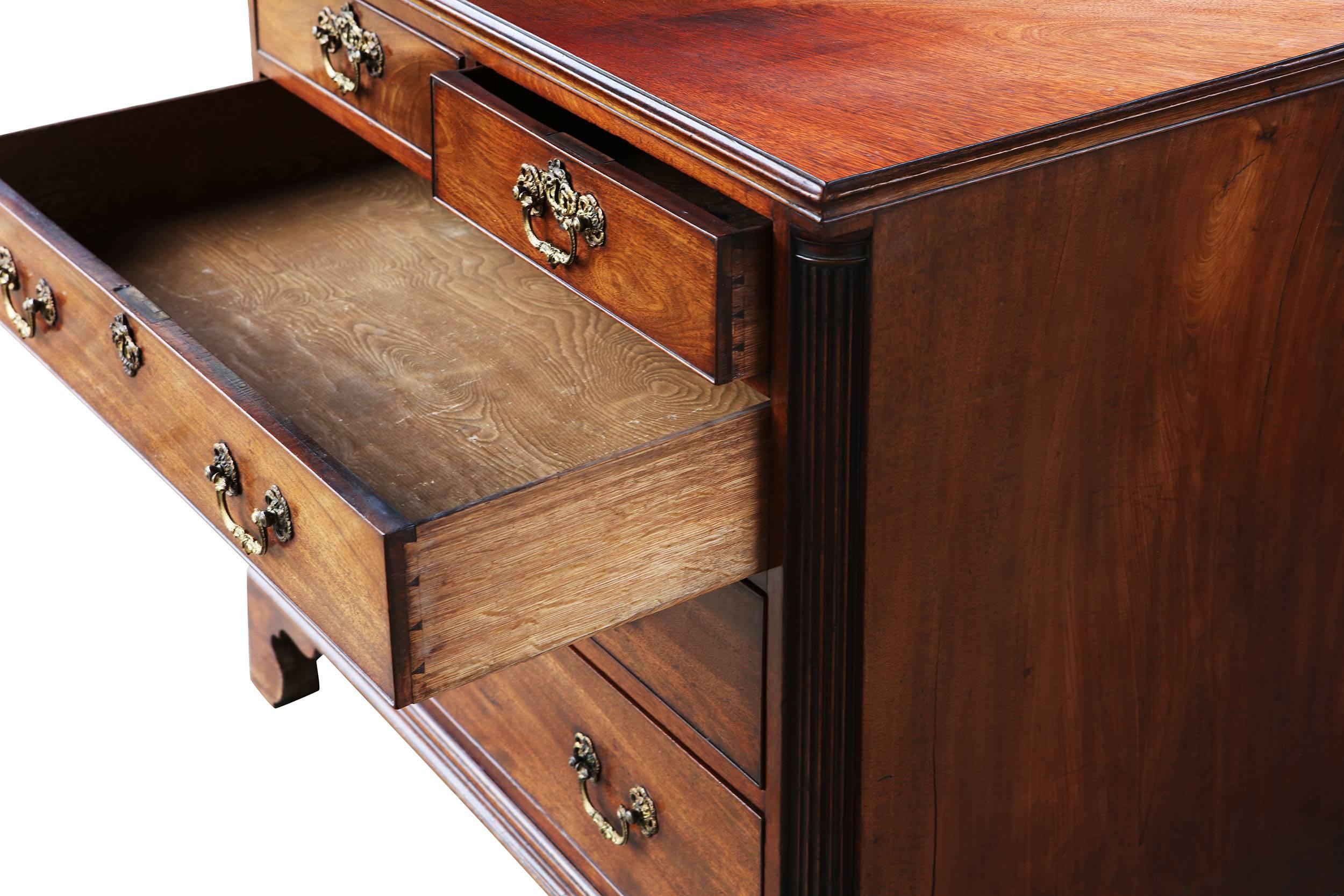 A very fine mid-18th century George II mahogany chest of drawers with two short above three graduated long drawers retaining their original lacquered brass hardware, the front corners with recessed fluted quarter column pilasters, the whole raised