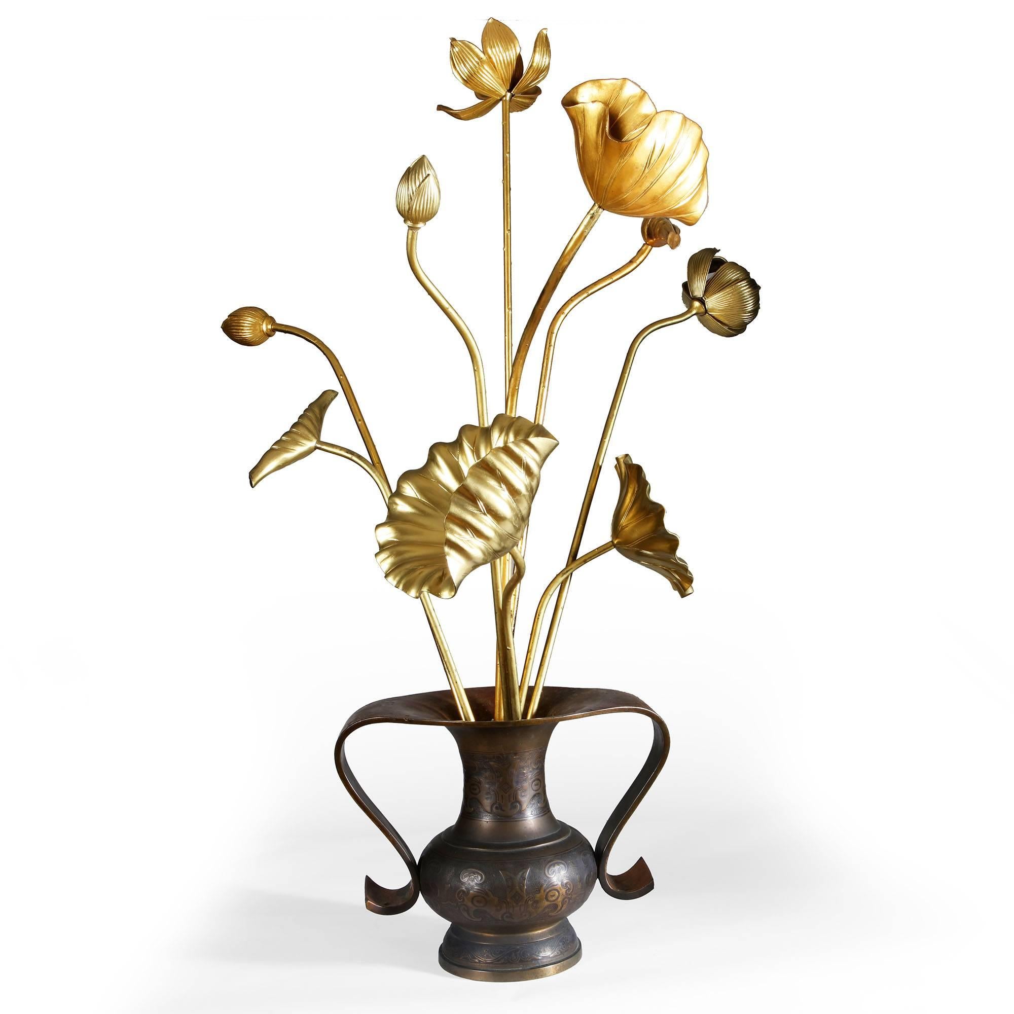 A collection of over-scale Japanese gold lacquered lotus flowers and leaves on stems, shown in a pair of Mimikuchi flying handle vases (Available Separately).

Measures: Tallest flower 122cm.
 