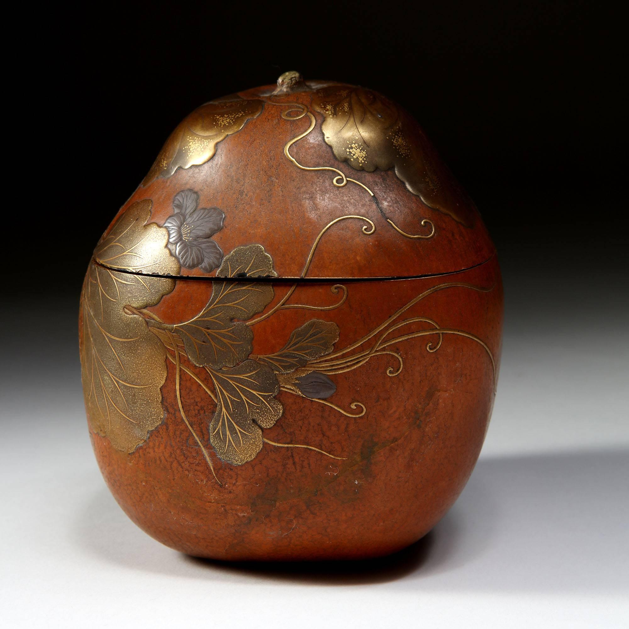 A dine 19th century Japanese gourd decorated with fine naturalistic gilt and lacquer leaves and tendrils. The interior opening to dark lacquer with gilt and red flecks.

Measures: Height 11.5cm
Diameter 10.5cm.